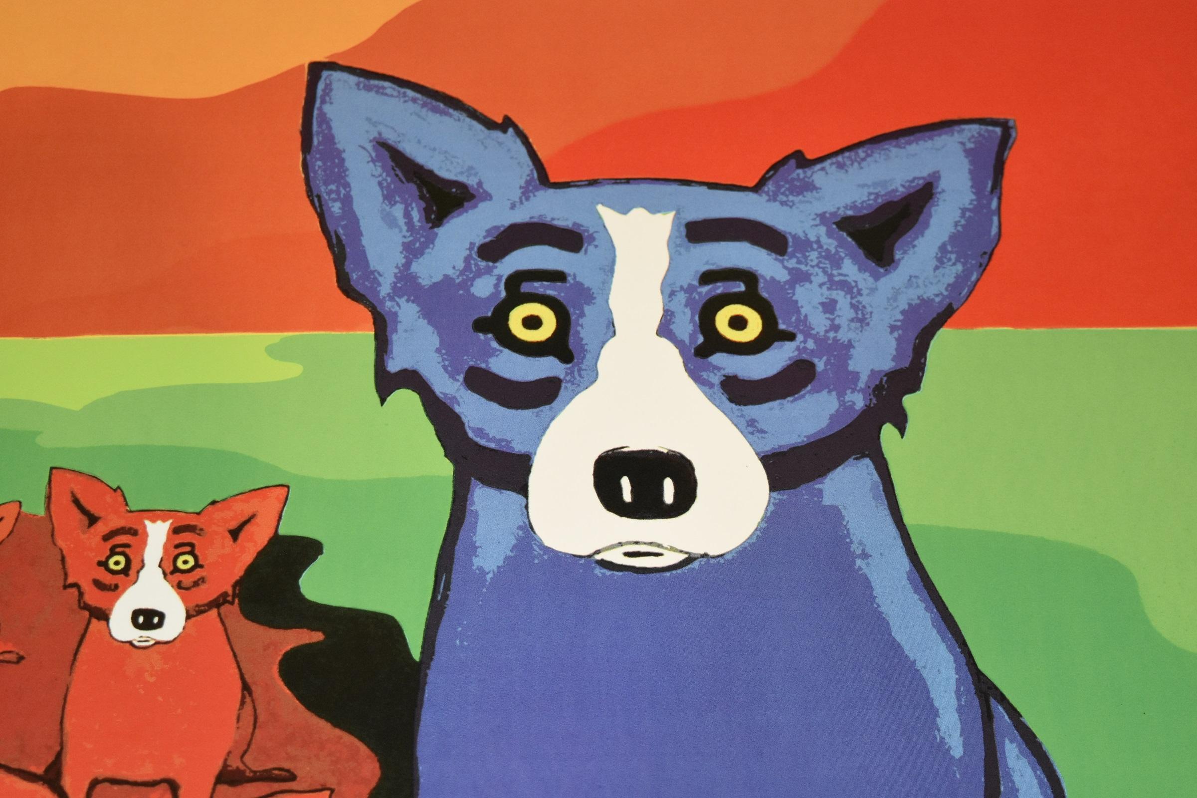This Blue Dog work consists of two blue dogs posted on either side of a red-flowing river of red dogs.  There is a yellow moon, a green river bank, and orange shades of mountains and sky.  The dogs have soulful yellow eyes.  This pop art animal