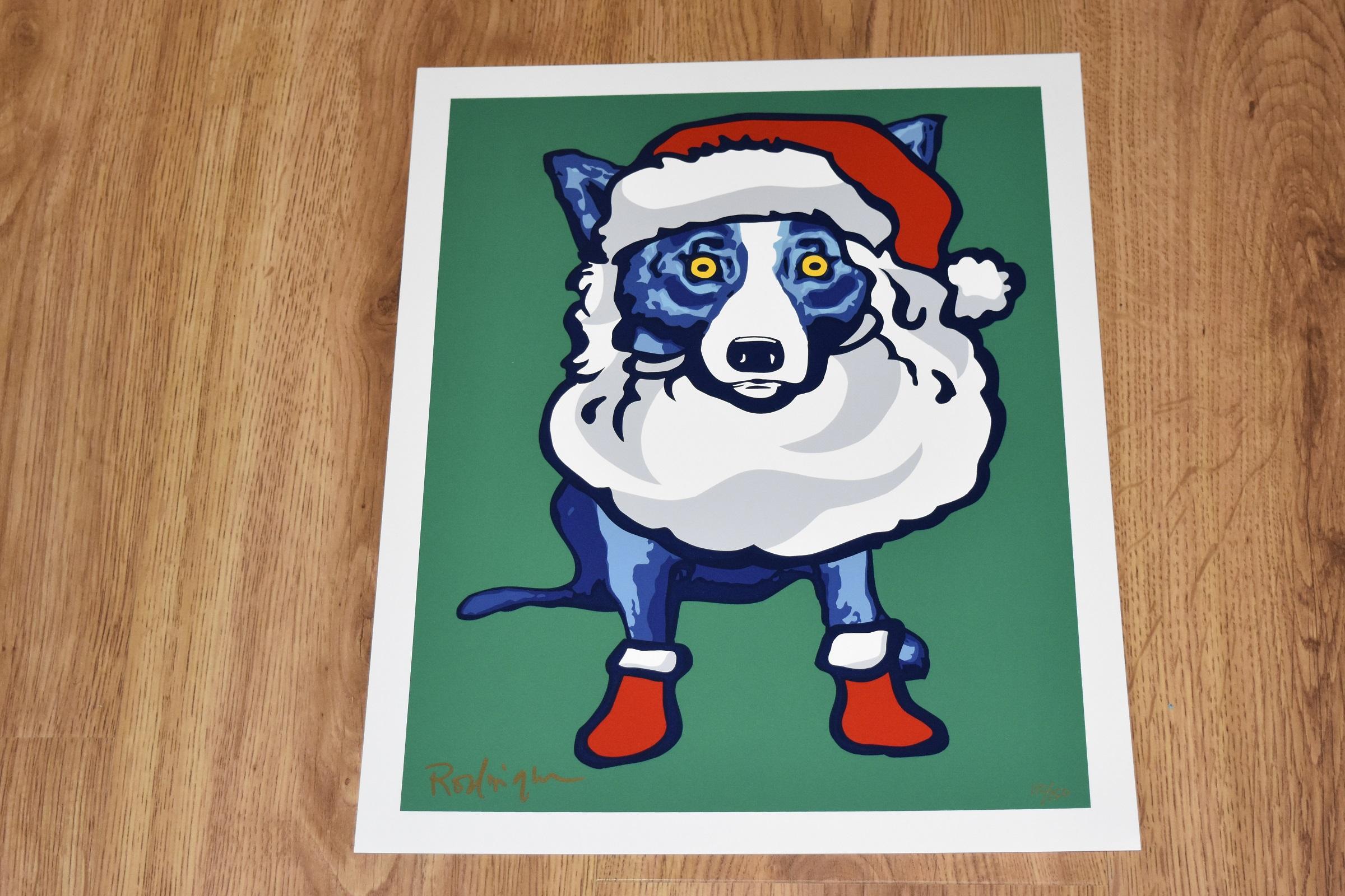 This Blue Dog work consists of a dog wearing a Santa red and white hat and booties, donning a white Santa beard and strands of white hair on a green background.  The dog has soulful yellow eyes.  This pop art animal original silkscreen print on