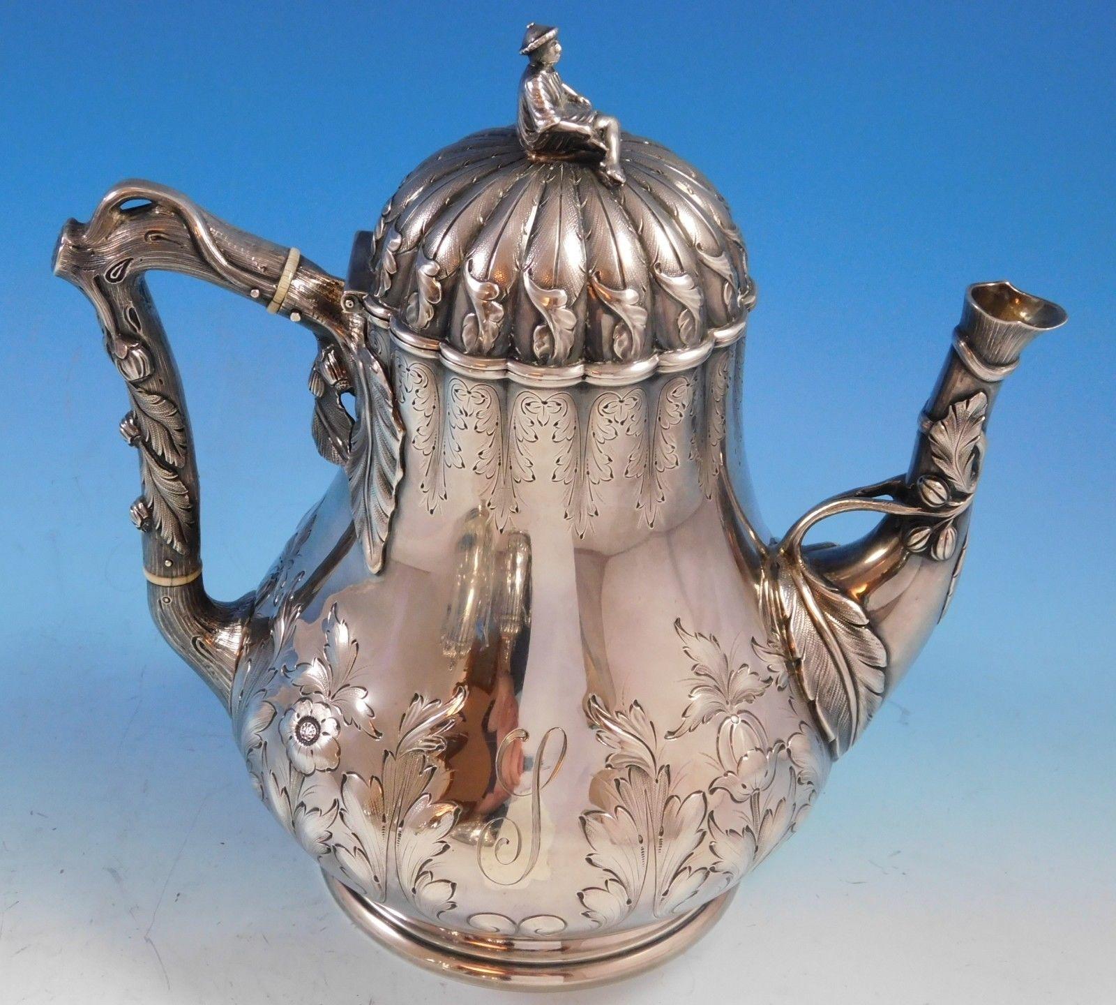 George Sharp

Four-piece sterling silver tea set made by George Sharp featuring 3-D cast finials of different Japanese figures, hand chased design, and faux bark/tree branch handles. The coffee pot has a figural spout. This set includes:

One coffee