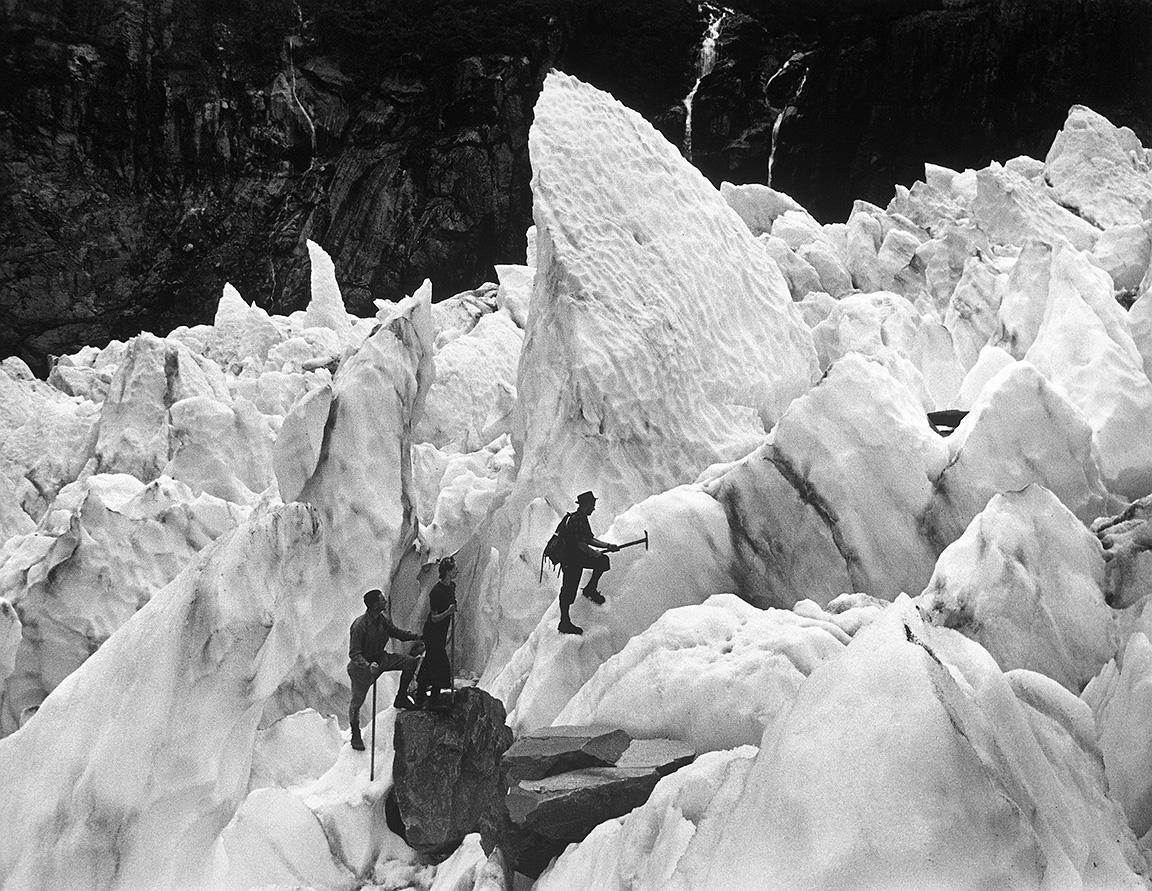 George Silk Black and White Photograph - Tourists Climb Fox Glacier in Tasman National Park, New Zealand, 1946