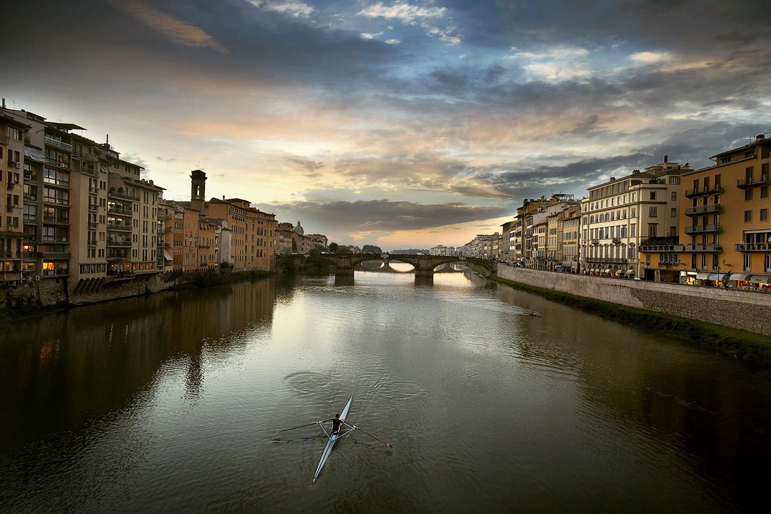 Sculling the Arno, Florence, Italy. - Photograph by George Simhoni