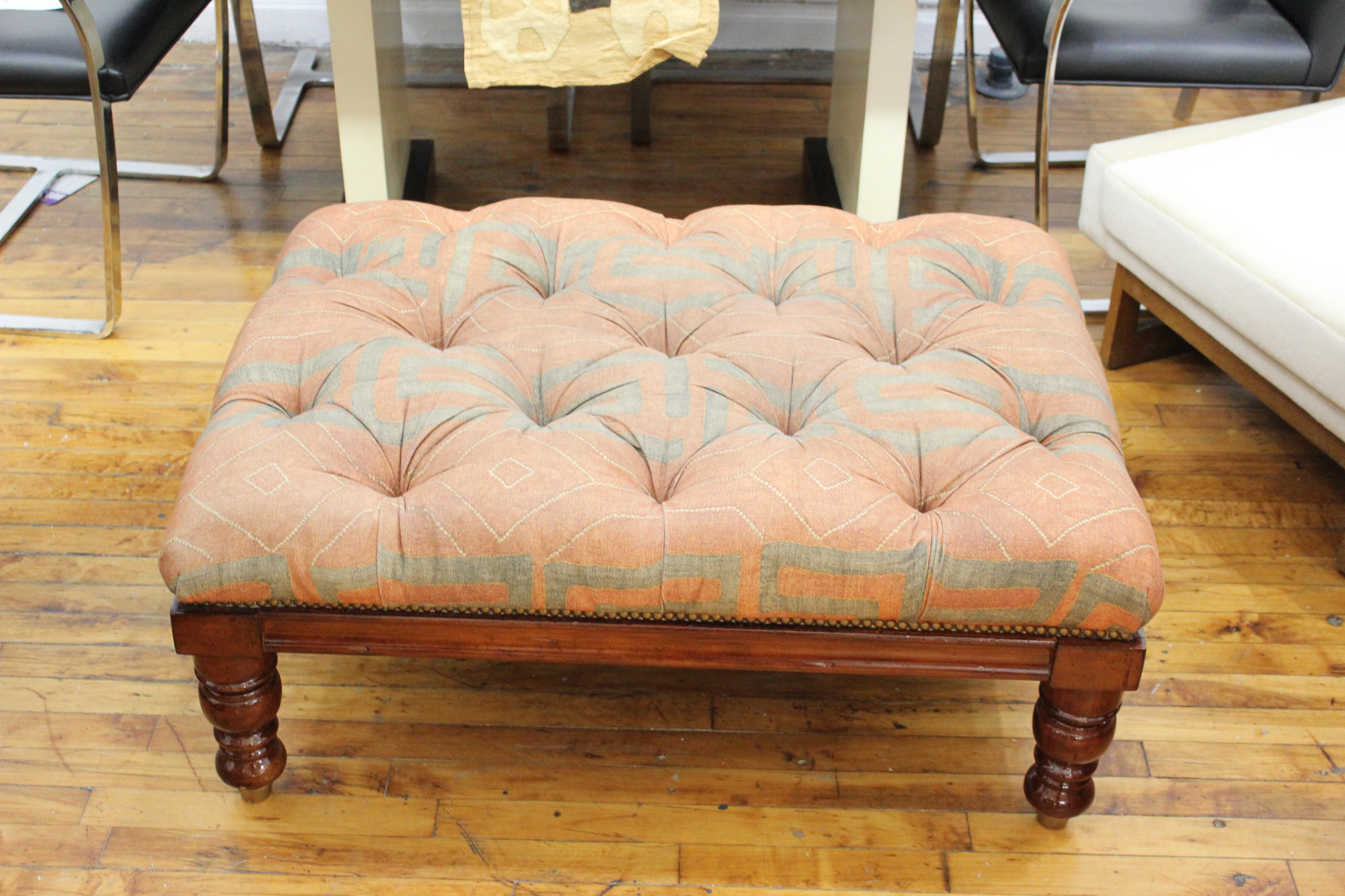 George Smith attributed English large ottoman with turned wood legs and tufted seat.