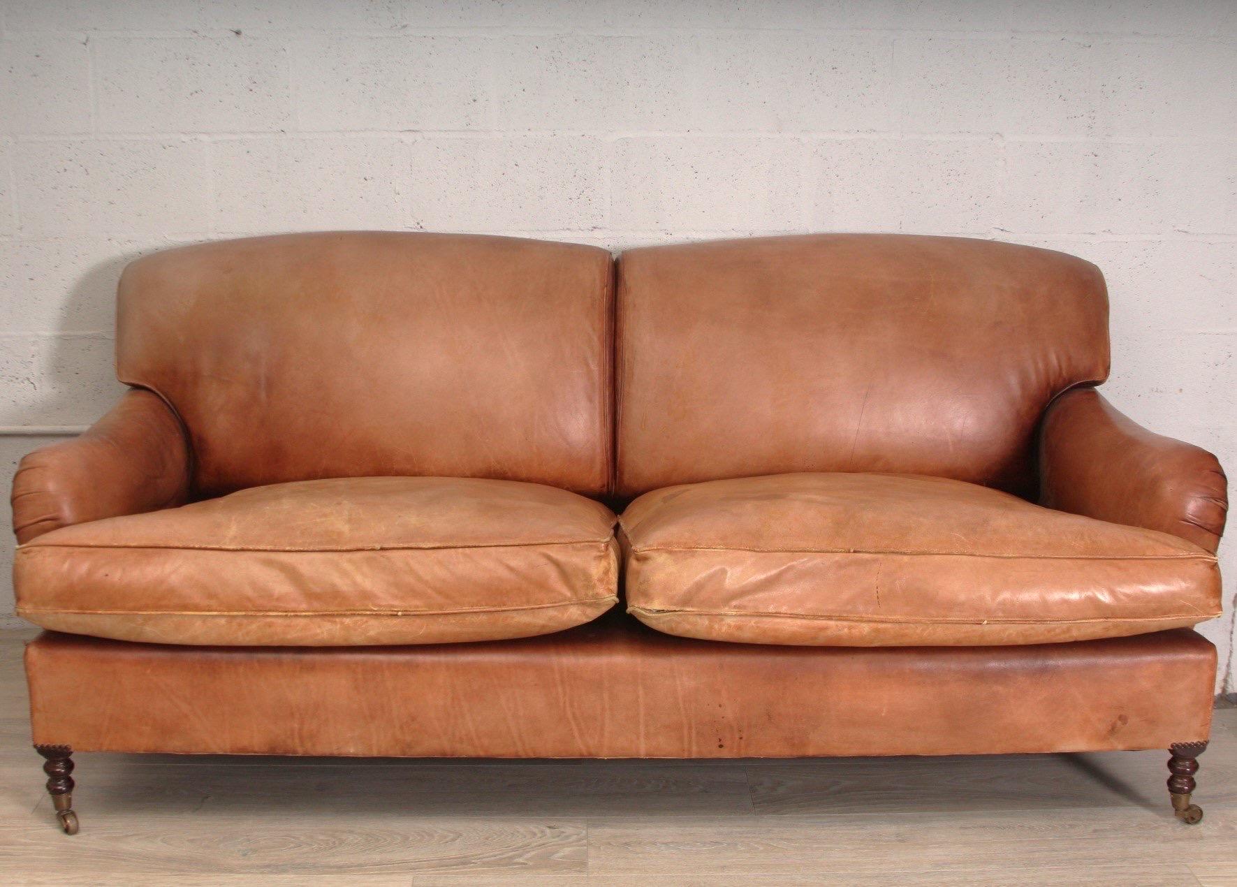 George Smith Scroll Arm Sofa in Cognac brown leather.

Features sumptuous leather upholstery with scroll arms and deep button tufting.  Complemented by a robust, hand-built frame for enduring stability and support. 

Dimensions: 
78”L x 38”W x