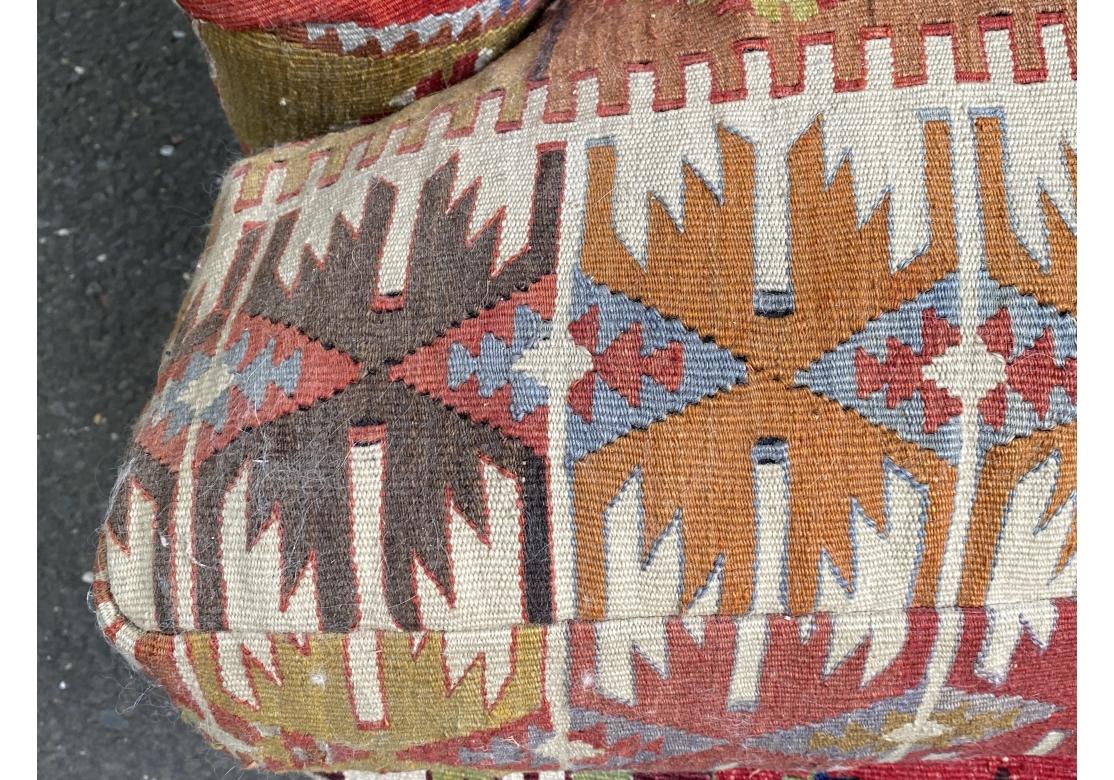 The famous Kilim Clad Sofa from master furniture maker George Smith. Hand made in England. A comfortable vintage three seat sofa with shaped and rolled crest rail and rolled pleated arms. With a three cushion deep seat and upholstered overall in