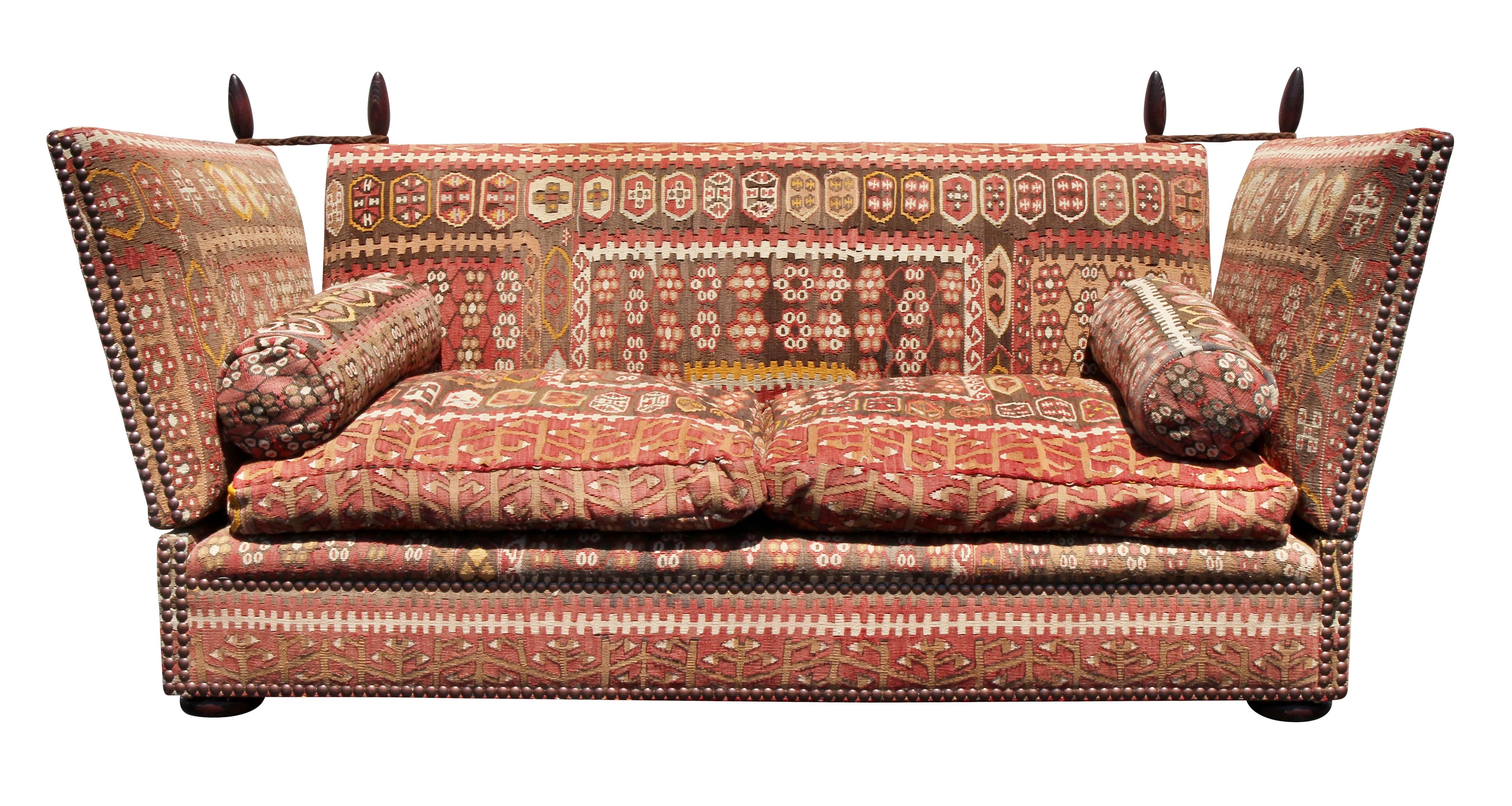Typical form with rectangular back and adjustable fold down arms with rope and peg holders. Brass tacked overall edges. Upholstered overall front back and sides with Kilim fabric. Two loose cushion seat down filled cushions. Includes two bolster