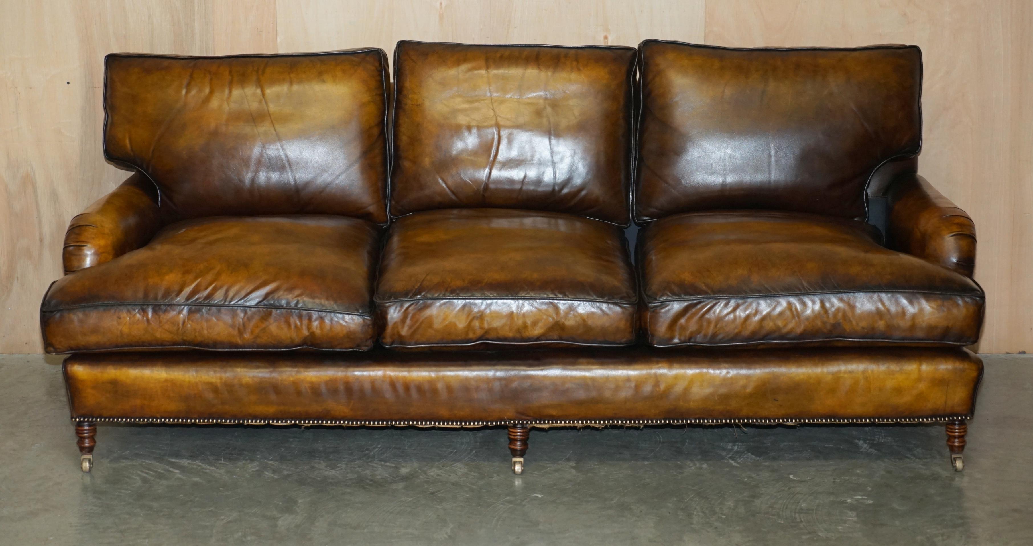 Royal House Antiques

Royal House Antiques is delighted to offer for sale one of two fully restored, deep seated, George Smith Signature Scroll Arm large sofas with feather filled base cushions upholstered with the original Heritage brown leather