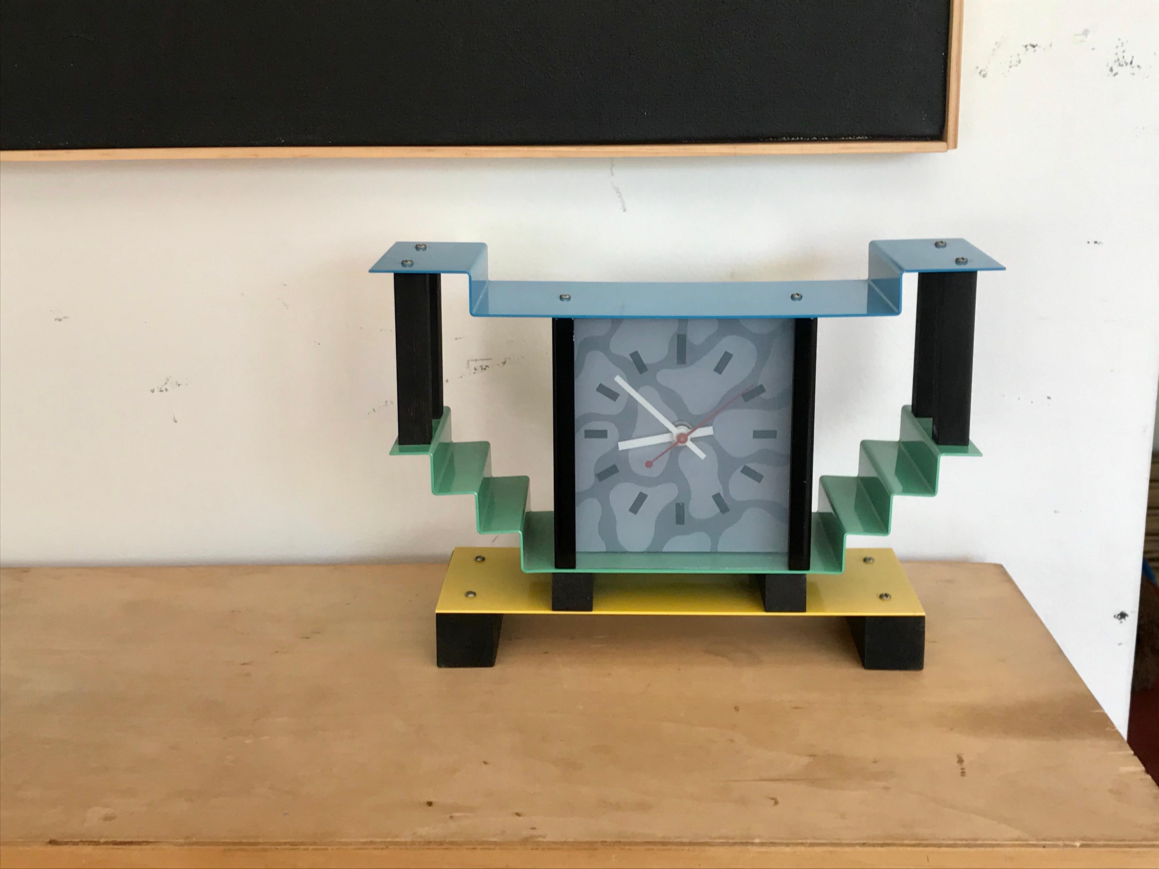 Architectural whimsy design.
Fun colors.
Form + function.
Enameled steel, wood and glass.
Battery operated.
Works fine.
Small blemish atop.
Add to collections and enjoy the aesthetics.

