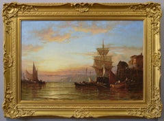 19th Century seascape oil painting of fishing boats beside a quay at sunset 