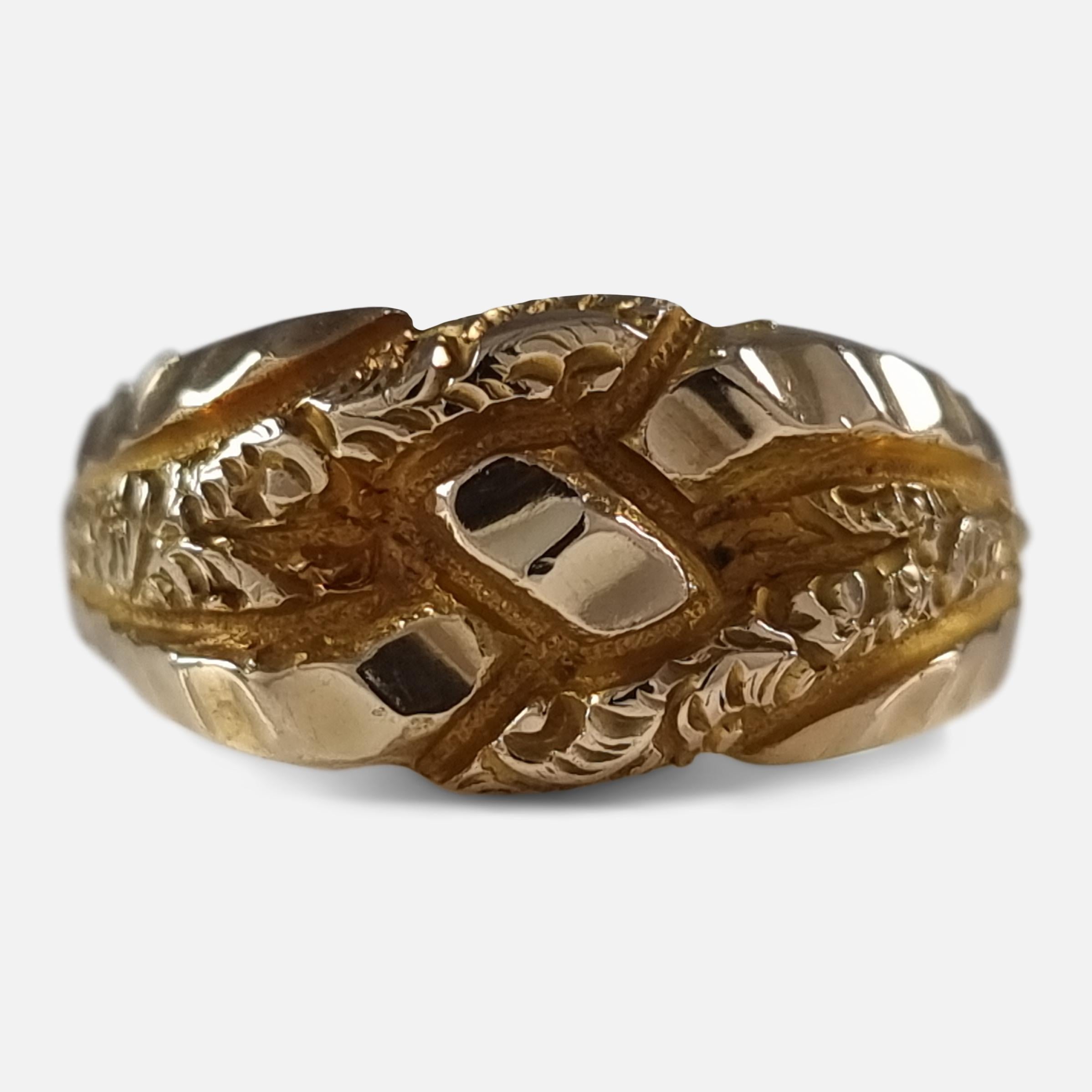 A George V 18ct yellow gold Keeper ring. The ring is engraved to the front with an overlapping, and scroll decoration.

The ring is hallmarked with Birmingham marks, '18' for 18 carat gold, and date letter 'q' to denote 1915.

Assay: - .750 Gold