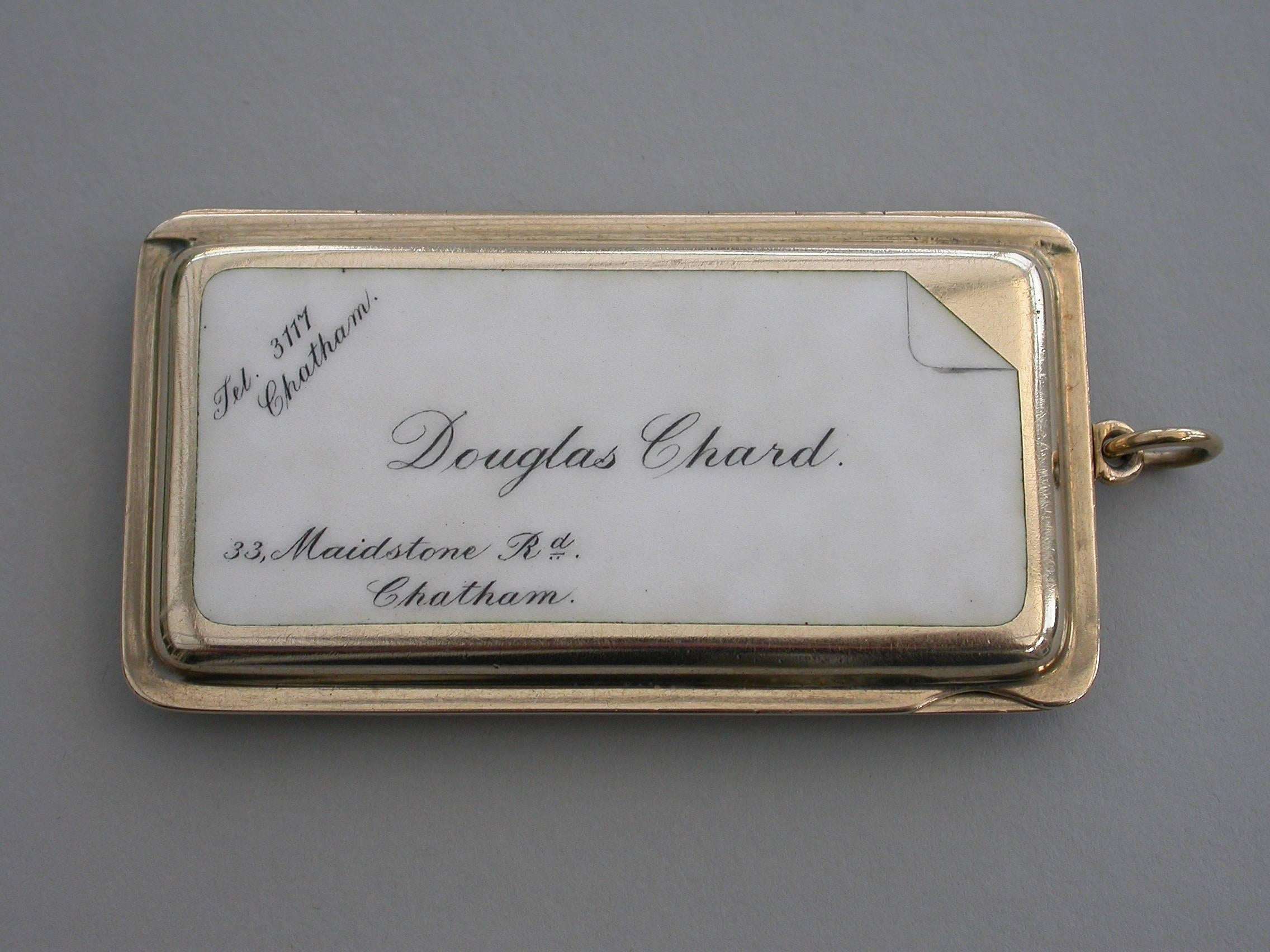 A good quality early 20th century 9-carat gold and enamel 'Calling Card Case' of shaped rectangular form with attached suspension ring and sprung hinged opening mechanism, the base with engine turned decoration, the lid inset with a calling card in