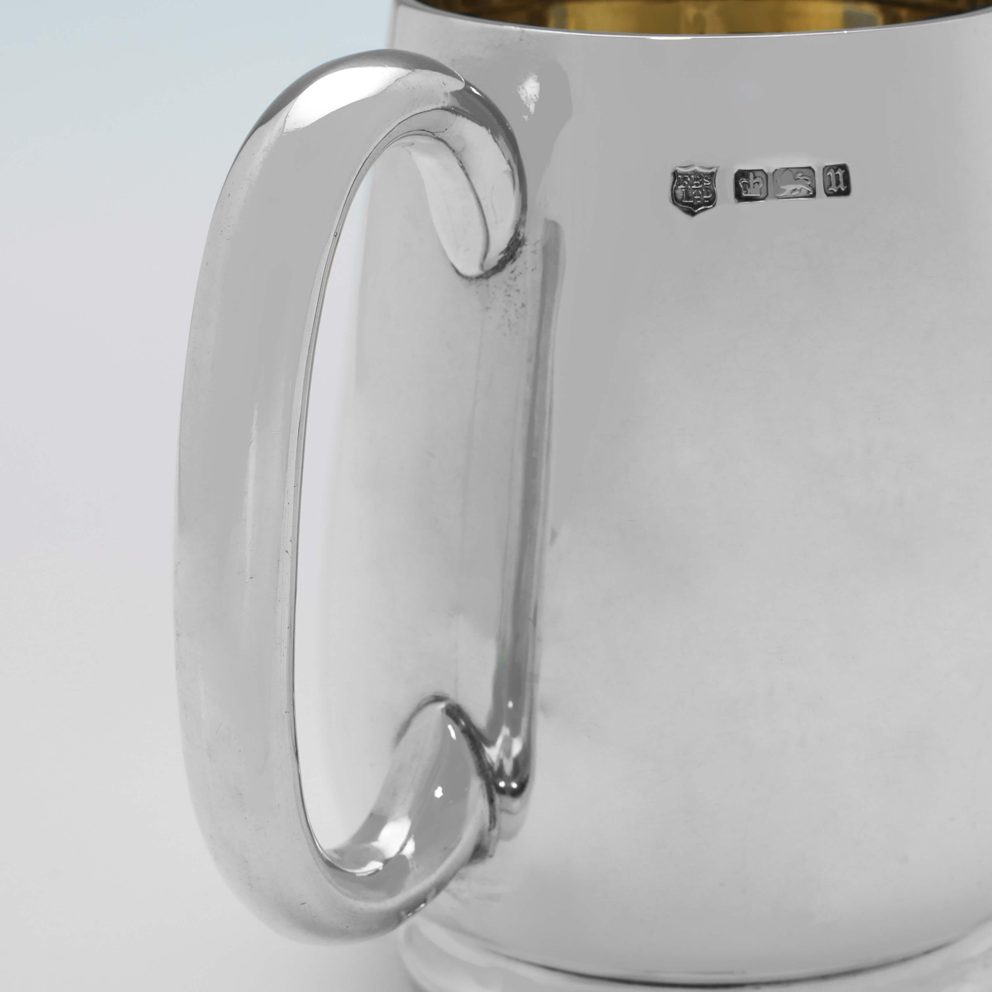 Hallmarked in sheffield in 1912 by Fenton Brothers Ltd., this handsome, antique sterling silver Christening mug, features a gilt interior, and a loop handle. 

The mug measures: 3.75