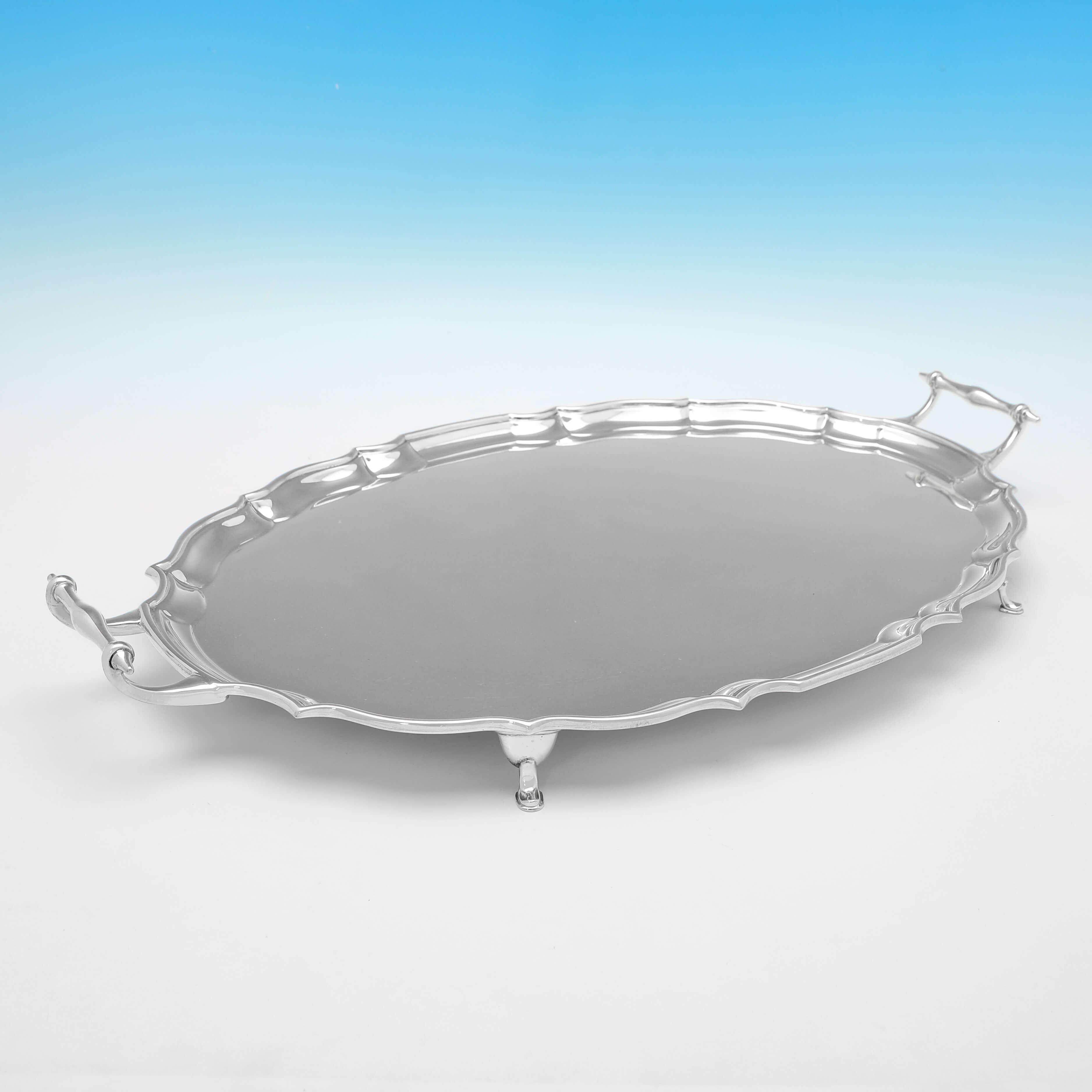 Hallmarked in Chester in 1911 by Barker Brothers Ltd., this handsome, Antique Sterling Silver Tray, features a shaped border, and stands on four feet. 

The tray measures 2.5