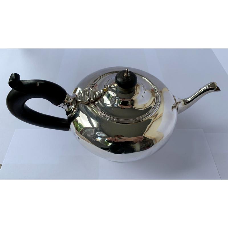 In good vintage condition, this is a beautiful teapot. It sits on a round pedestal base and has a lovely curved wooden handle and finial. There is a little dent in the handle at the top and a tiny ding on the side of the pot.
Hallmarked: Made by C S
