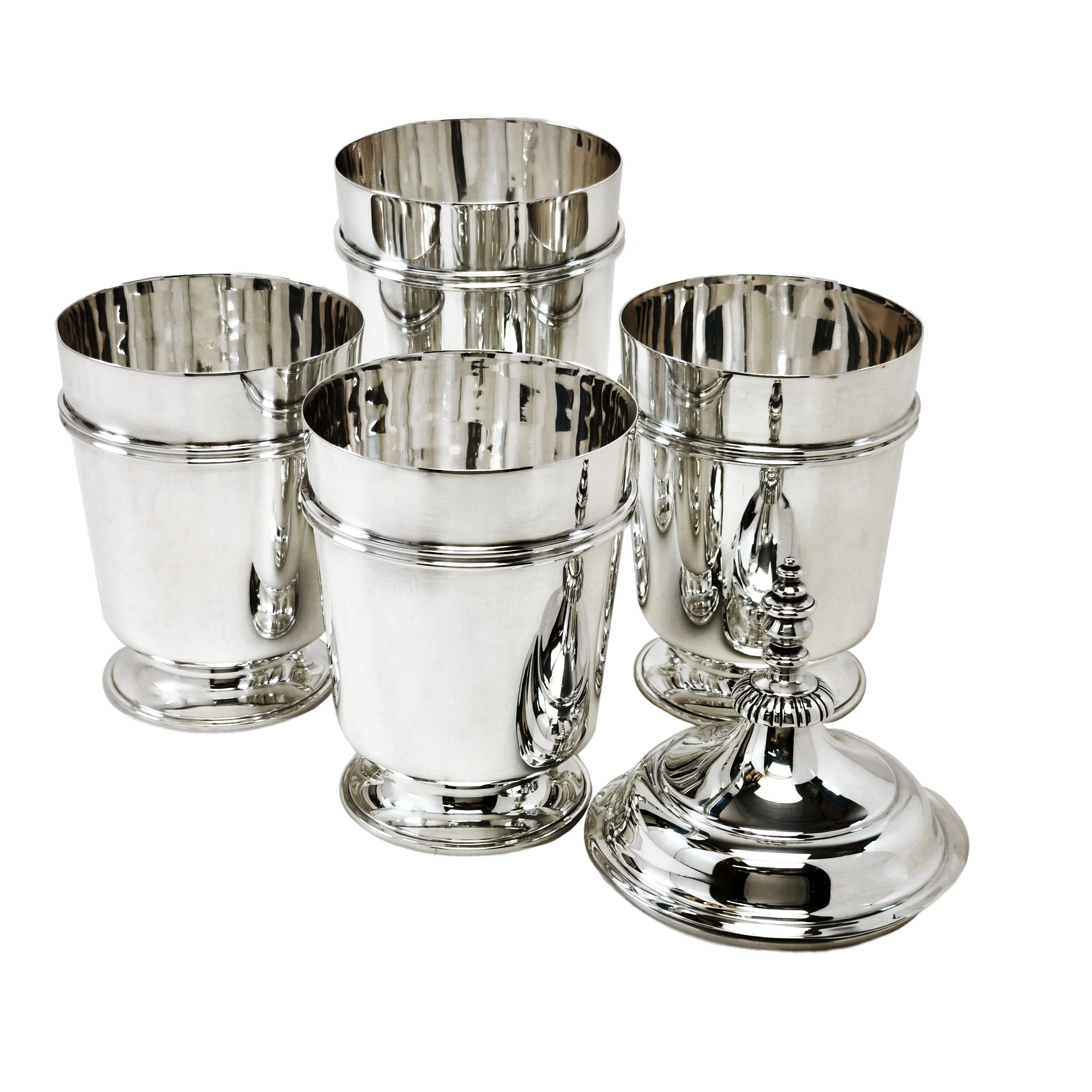 An impressive Set of 4 George V Sterling Silver Stacking Beakers in the style of a set from the reign of Charles II (from 1660). This Set up cups features 4 straight sided beakers each with an applied band in on the body and standing on a spread