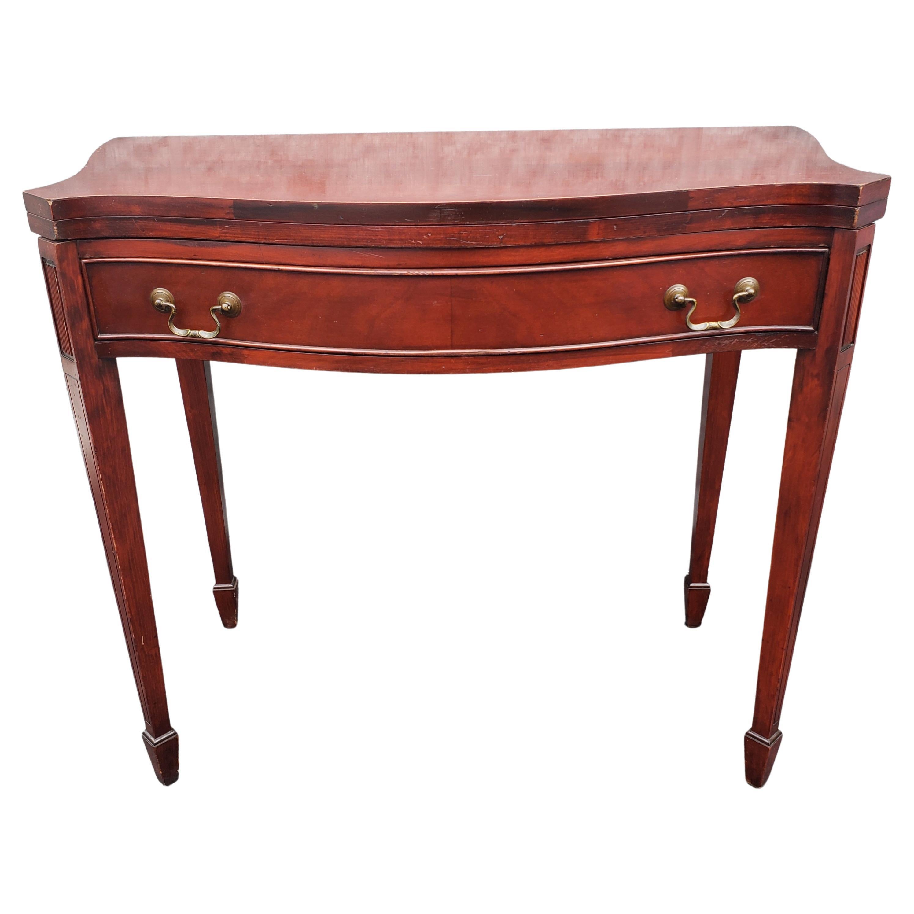 Offered for sale is this quality mahogany side table Shaped top in pure mahogany. Draw to the front against single large dovetailed drawer with brass Chippendale drop handles. Standing on square tapering legs and Offered in good clean vintage