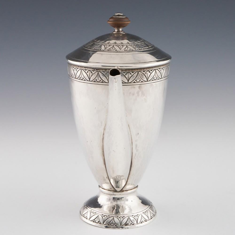 Heading : George V Sterling Silver Coffee Pot
Date : Hallmarked in Birmingham 1912 For William Hair Haseler
Period : George V
Origin : Birmingham England
Decoration : Turned fruitwood knop and handle. Engraved bands of repeated foliate design on the