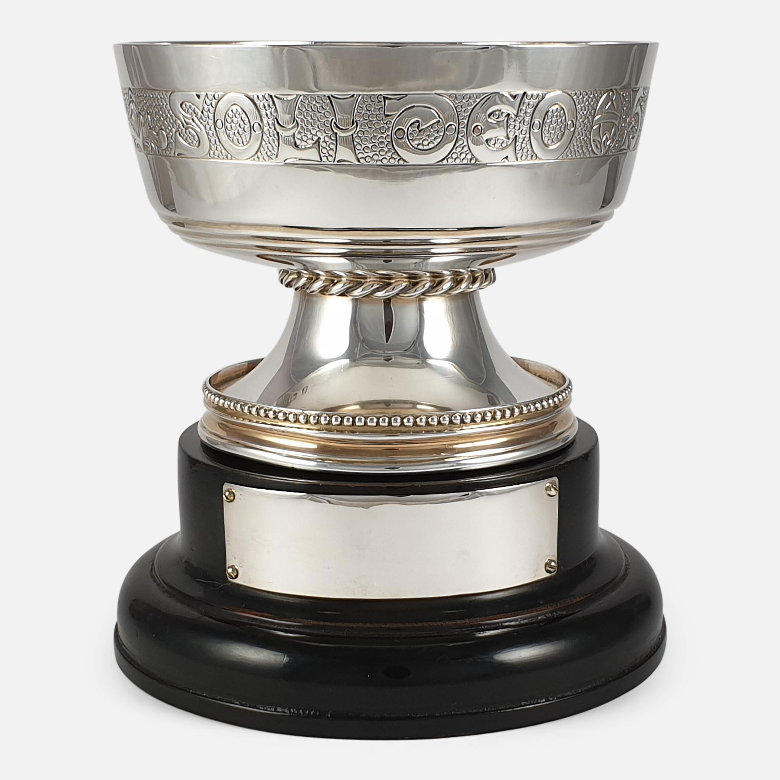 A George V sterling silver gilt replica Tudor chalice cup, and plinth with vacant plaque. The cup is of circular form, with a chased inscription on a matted background, the tapering foot with a rope-work girdle and chased border. The cup is crafted