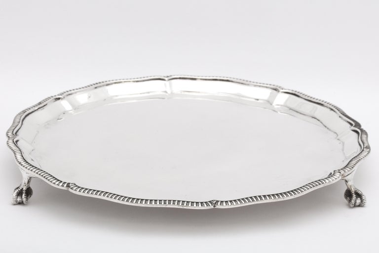 George V, sterling silver paw-footed salver, Sheffield, England, year-hallmarked for 1934, Mappin and Webb - makers. Also bears the mark for George V's coronation year (the King's head and the Queen's head) near the rest of the hallmarks. Reeded