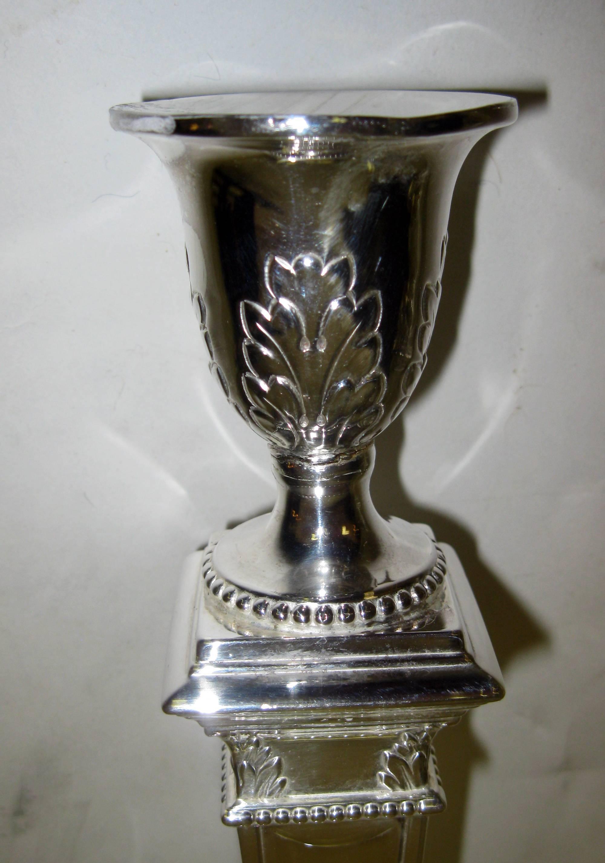 George V triple silver plated candlesticks feature acanthus leaf decoration with multiple bands of embossed bead decoration on stepped base as well as on the top. Because they are heavily weighted, they would make nice candlestick lamps if converted.