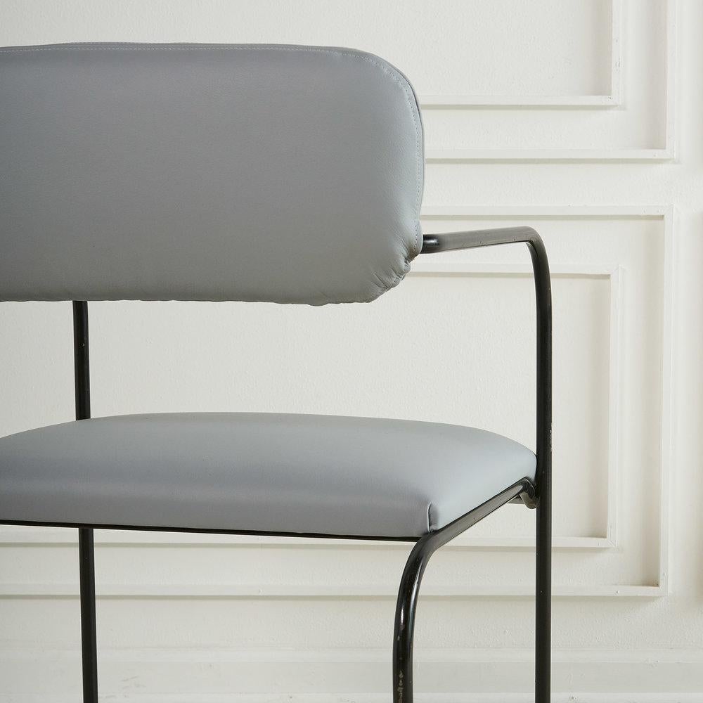 A set of 6 Roger Brown dining chairs fabricated in curvilinear black metal and reupholstered in buttery soft grey Italian leather. Roger Brown commissioned his partner, architect George Veronda, to design furniture for one of the several homes he