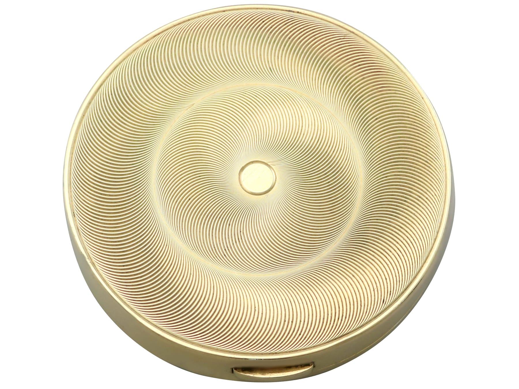 An exceptional, fine and impressive vintage 0.06 carat ruby, 0.24 carat diamond and 9 karat yellow gold mirror/powder compact made by Cartier; an addition to our Cartier collectables collection.

This exceptional vintage 9 karat yellow gold compact