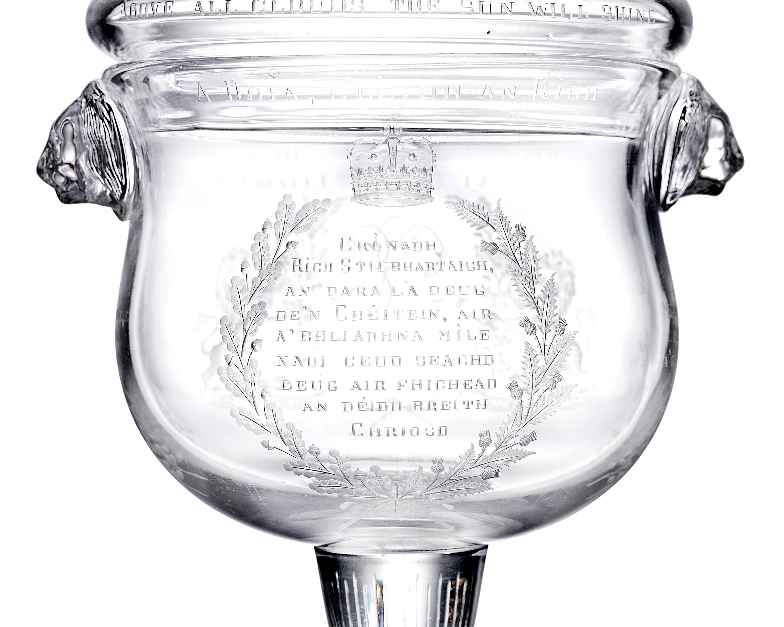 This limited edition covered goblet commemorates the 1937 coronation of King George VI and Queen Elizabeth. Crafted of glass with impressive lion mask handles, the cup features a number of engraved details, including the initials of the monarchs