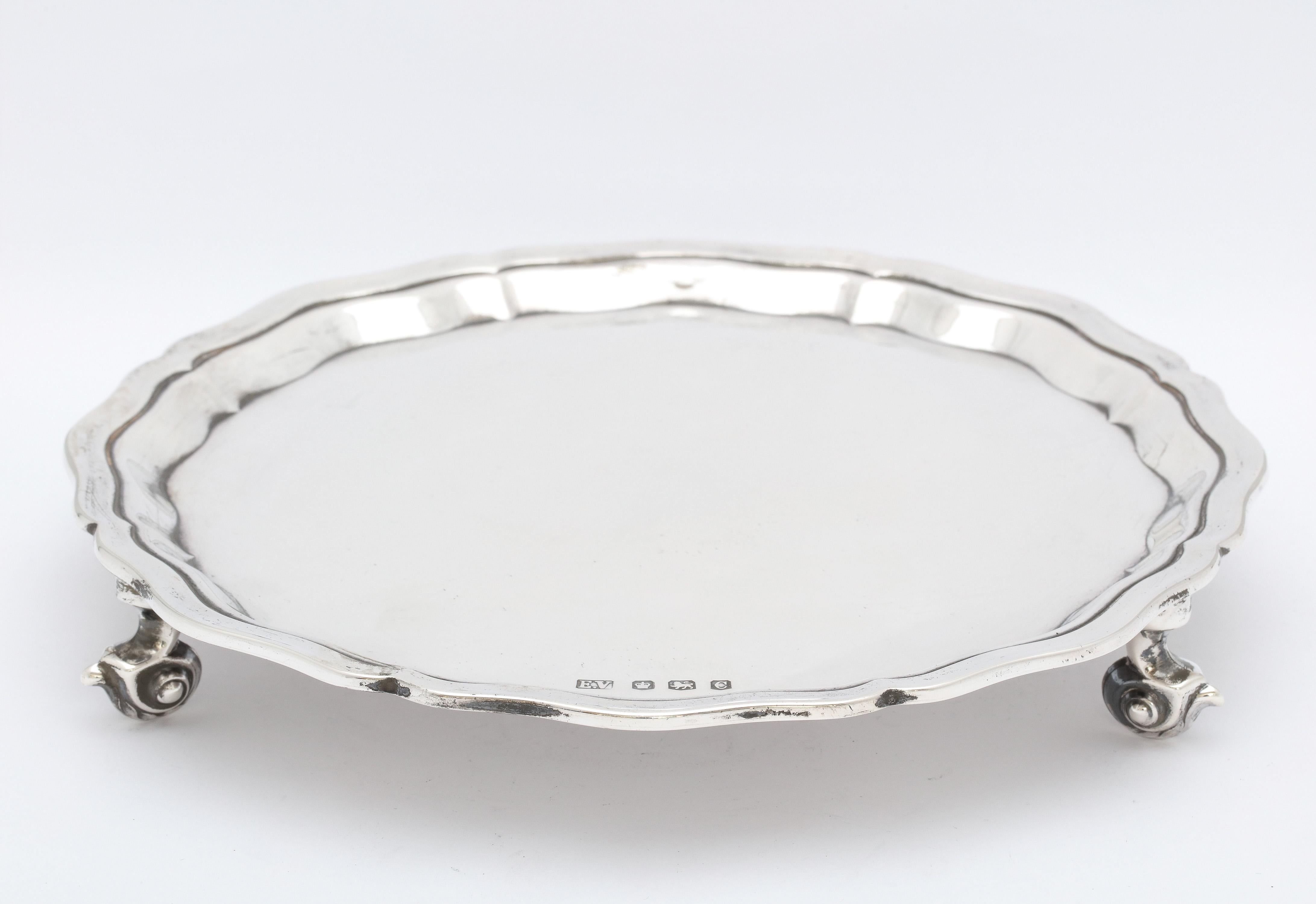 George VI Period, sterling silver footed salver/tray (in the George III Style), Sheffield, England, year-hallmarked for 1945, Emile Viner - maker. Scalloped border. Measures 8 inches diameter x 1 1/4 inches high. Weighs 10.235 Troy ounces. Dark