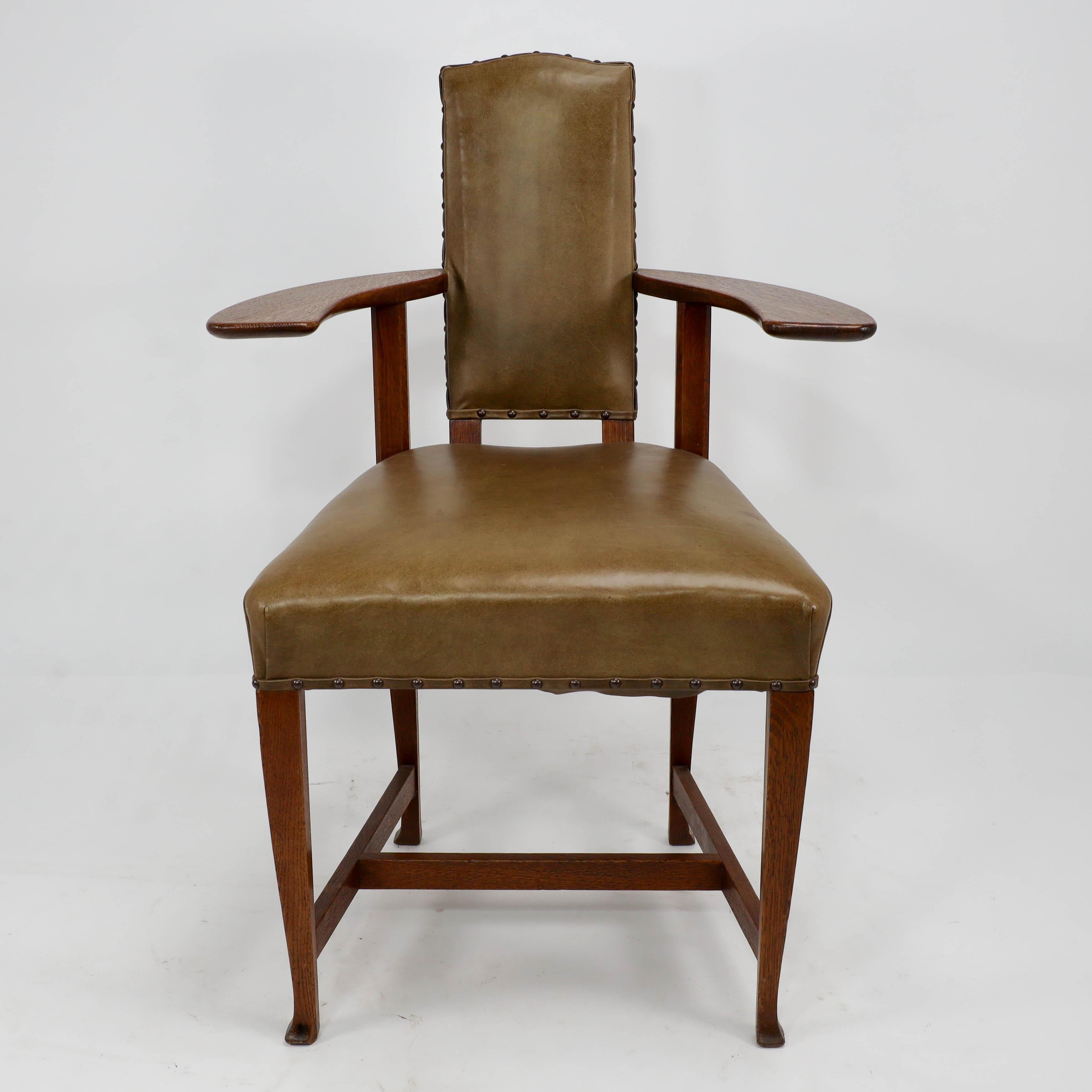 George Walton. A rare Arts & Crafts Glasgow School oak 'Abingdon' armchair. 
This design is quite radical, with large flat arms which protrude out incorporating the back legs and upright supports quite far back giving the chair a light and airy