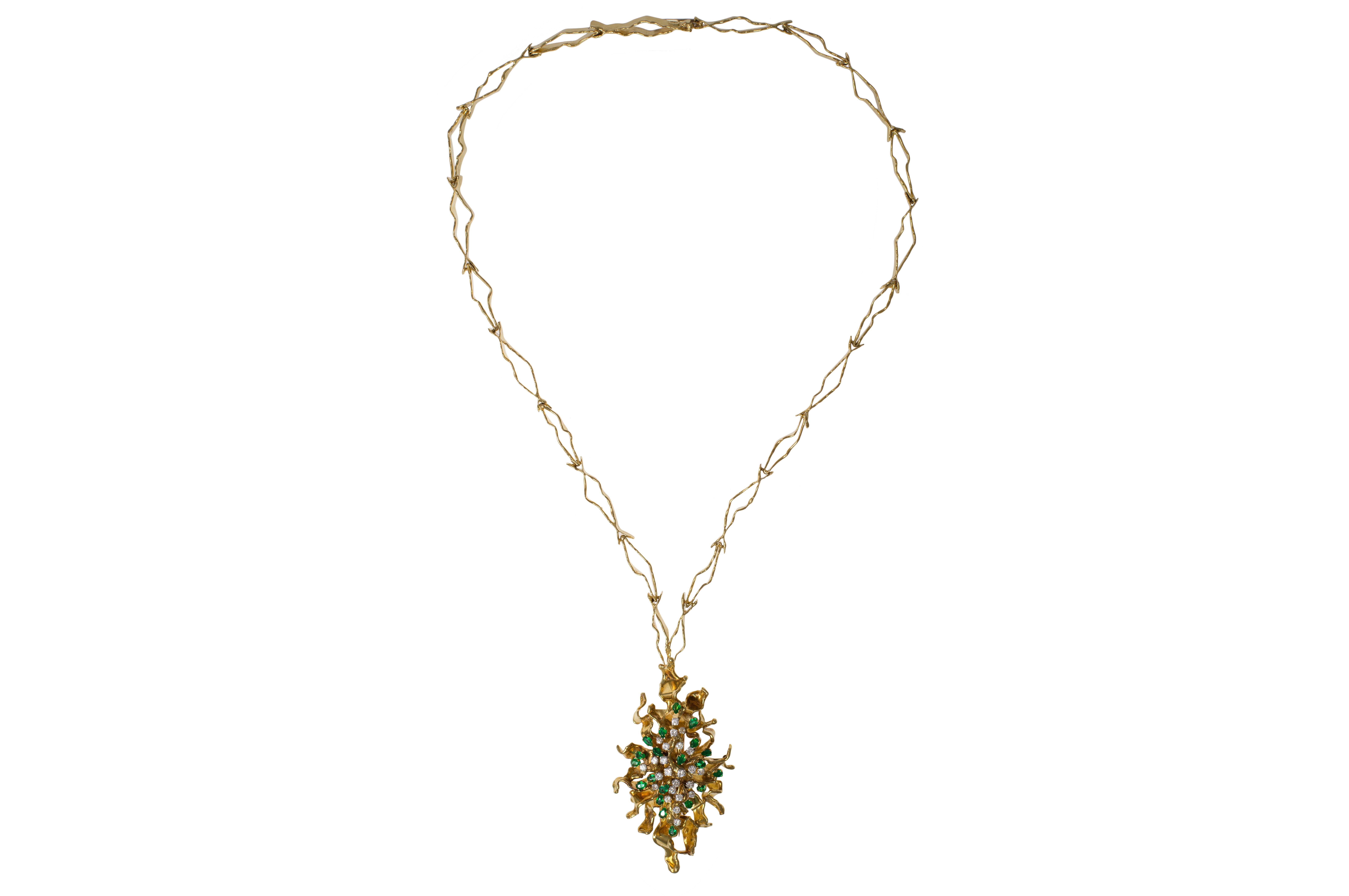 A one-of-a-kind, handmade, diamond, emerald and textured 18 karat gold detachable brooch-pendant, on a textured 18k gold chain, by London artist and jeweler George Weil, c. 1970. 