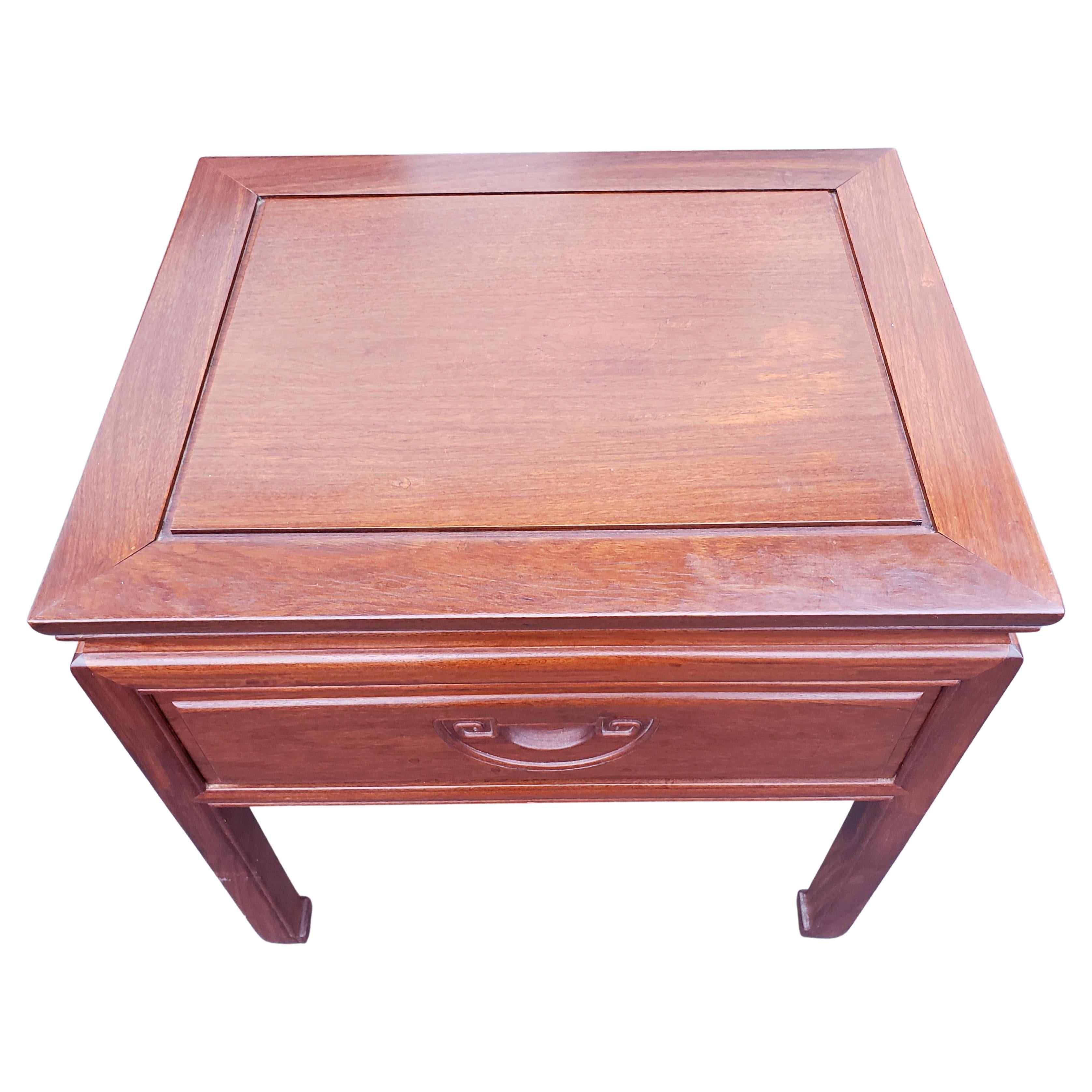 Pair of rosewood hand crafted side tables with integrated carved handles. Very good condition. Devetailed drawer. Finished on all sides, inside out. Matching chest of drawers in our inventory.
Measurements: 24