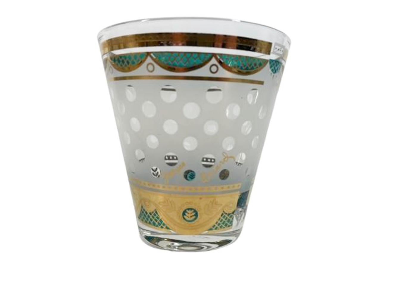 Set of four mid-century double old fashioned glasses designed and signed by Georges Briard having a frosted ground with clear polka dots between borders of 22k gold and green enamel swags.