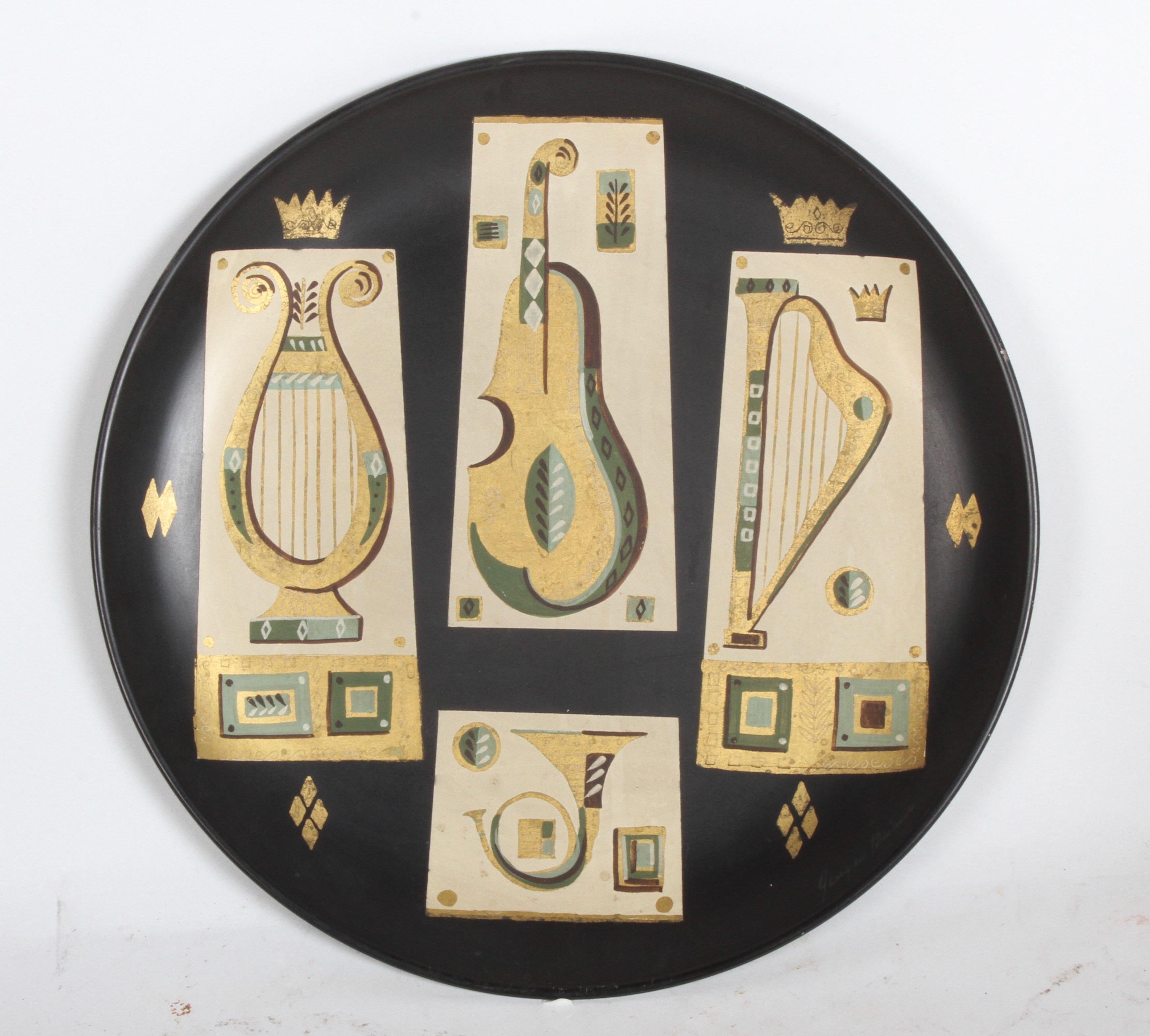 Grand plateau en métal Georges Briard conçu pour être accroché au mur, ayant des instruments de musique à thème peints à la main et dorés à l'or fin avec la basse, la harpe et le cor. Possède une étiquette au dos lors de son achat en 1955. Signé en