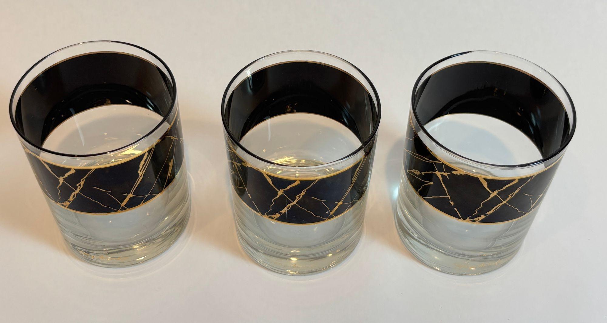 Set of 3 Signed Georges Briard Lowball Glasses — Black Band with 22K Gold Splatter, c. 1960s
A striking example of mid-century sophistication, this set of three vintage lowball glasses by acclaimed designer Georges Briard embodies the glamour and
