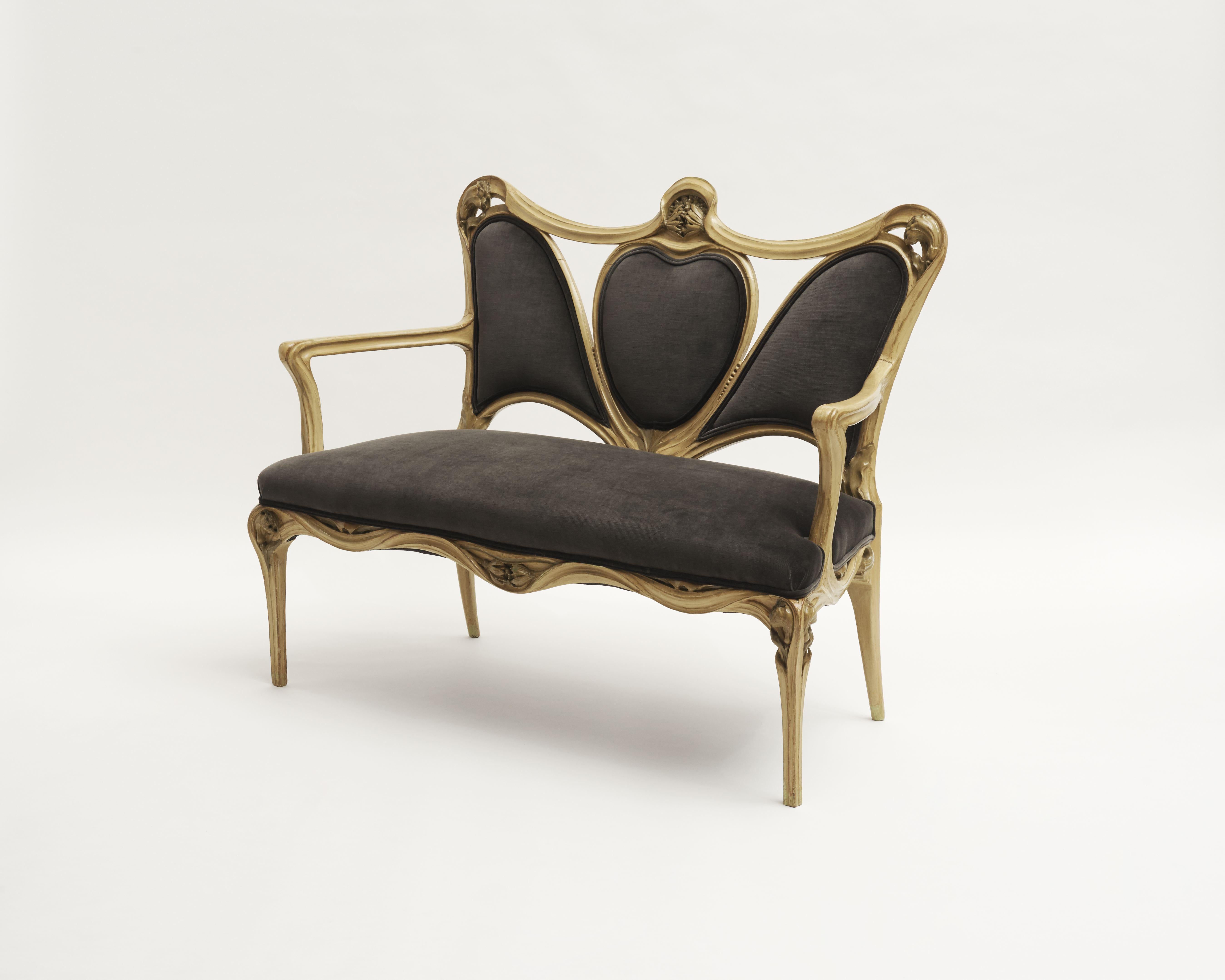 This settee is typical of De Feure’s style at the turn of the 20th century. The high back with swooping lines, paired with straight legs curving toward their meeting with the seat, is reminiscent of pieces De Feure created for the, 1900 Paris