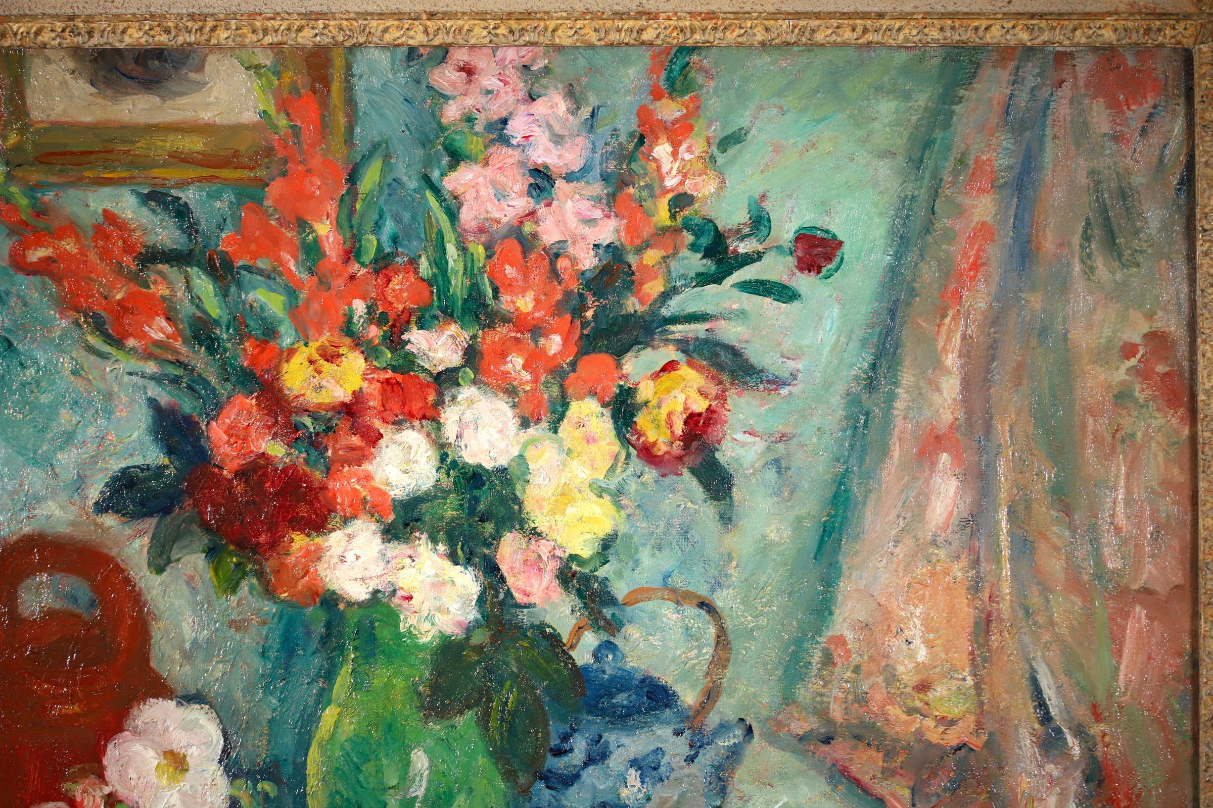 A wonderful still life oil on canvas circa 1920 by French painter Georges d'Espagnat. The piece depicts vases of flowers, a blue and a red teapot and a plate of fruit on a table in a blue interior. Titled 