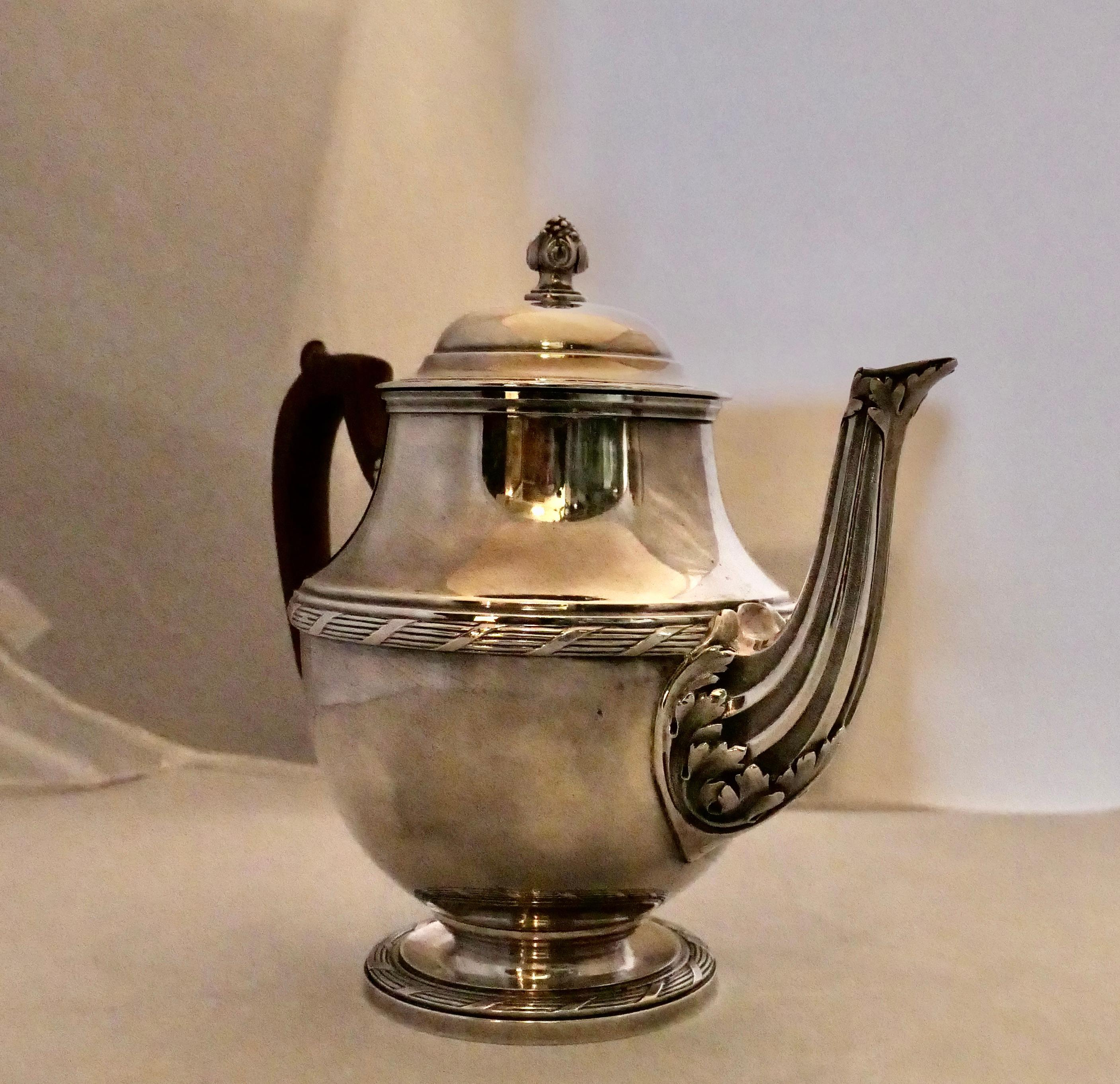 This vintage rare French sterling silver tea pot is beautifully designed by Georges Fouquet-Lapar in the 1930’s. It is stylishly decorated with an elaborate spout & subtle banding. An elegant curved rosewood handle is attached to its body. The
