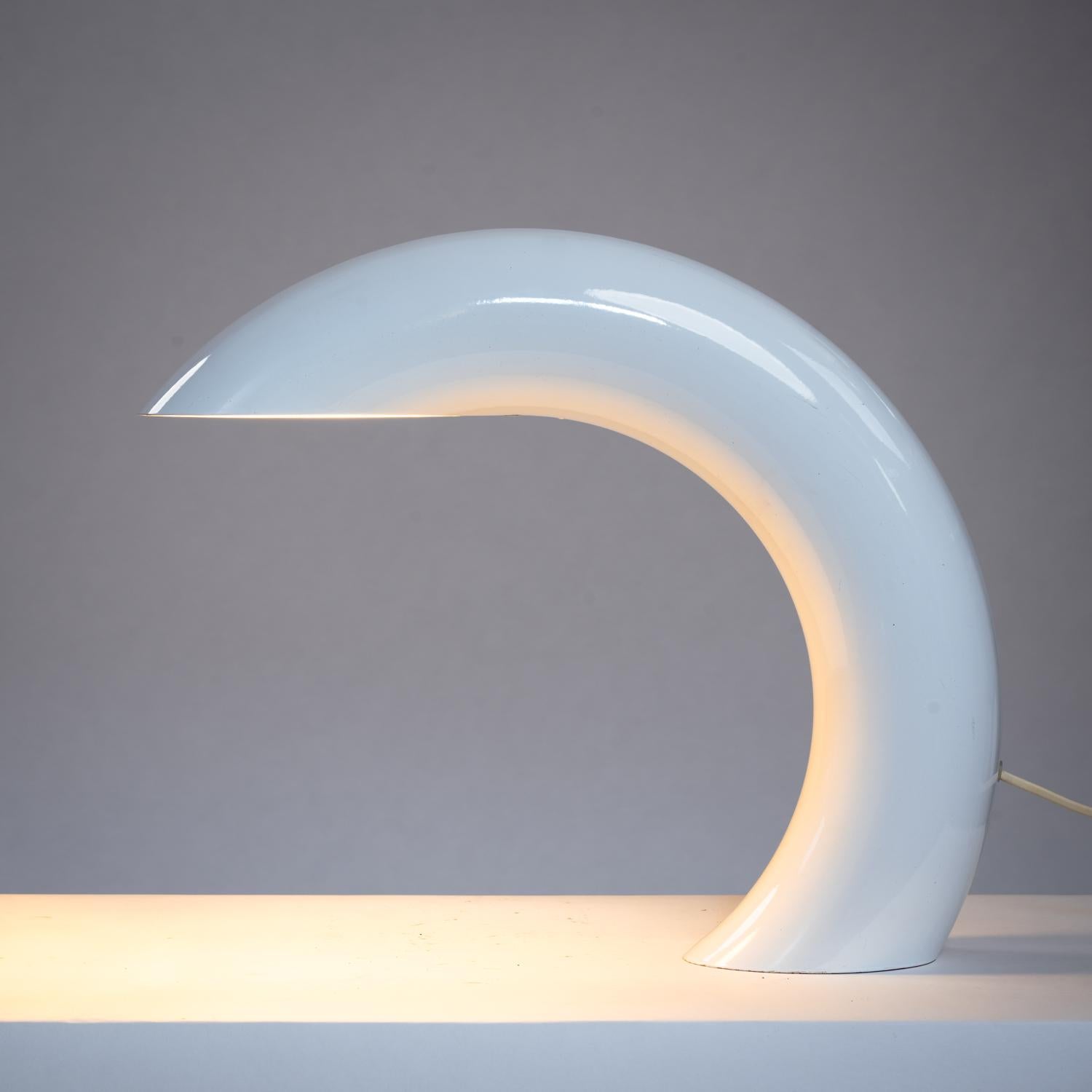 This sculptural arc shaped table lamp was designed by the French designer Georges Frydman. A minimalistic design of a solid circular tube made of (heavy) cast aluminum, finished with a white lacquer. This lamp gives a soft direct light and a