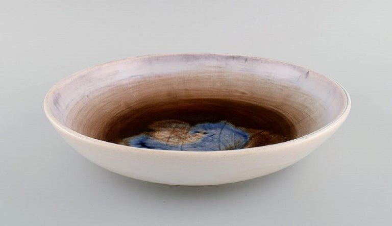 Georges Jouve (1910-1964), France. Unique bowl in glazed stoneware. Beautiful glaze in blue and light earth tones. 
Mid-20th century.
Measures: 29 x 6.3 cm.
In excellent condition.
Signed.

Georges Jouve was a French ceramicist considered one