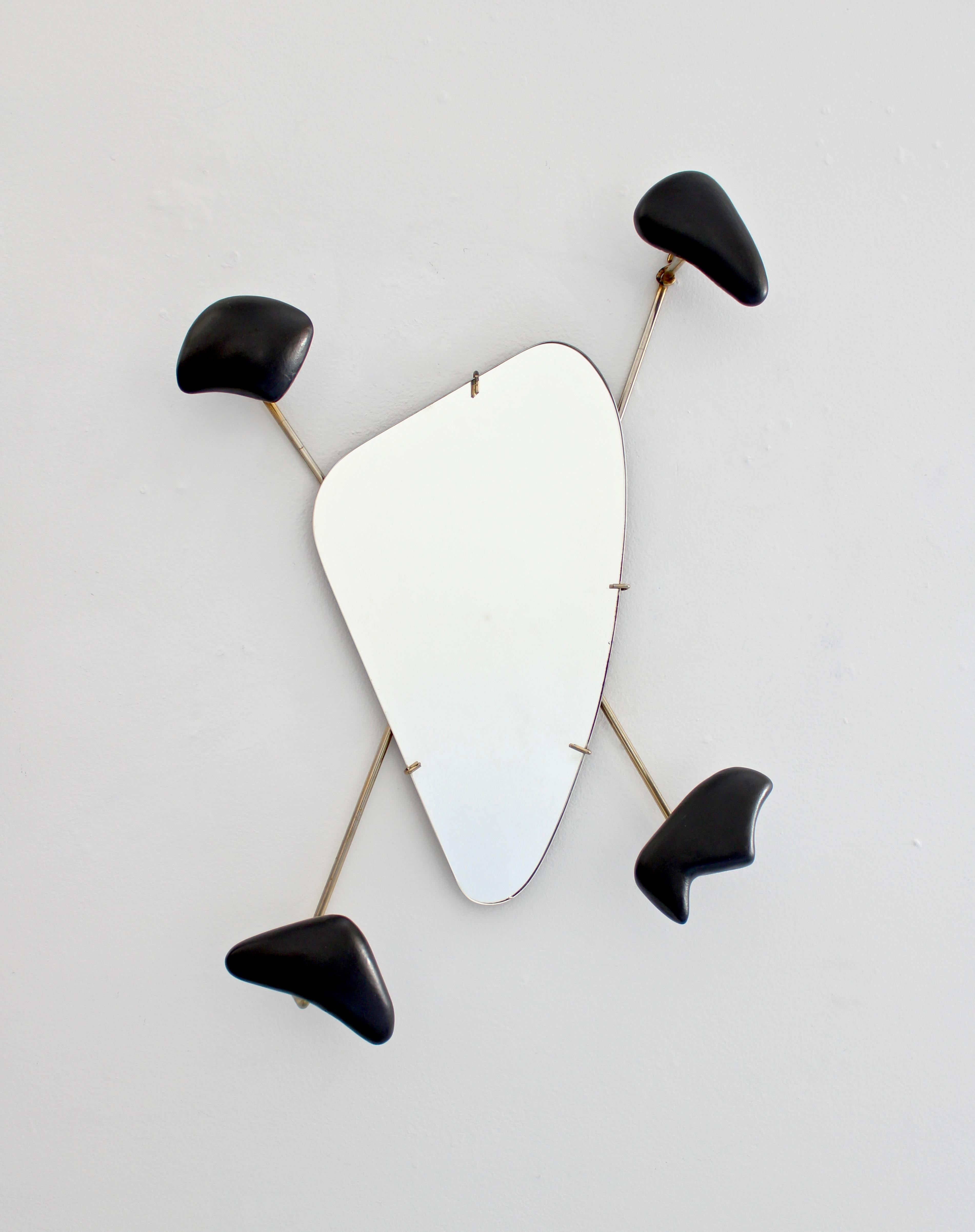 Wall-mounted coat or hat rack with mirror by Georges Jouve for Marcel Asselbur. Asselbur, France, 1955.
Glazed matte black stoneware forms, mirrored glass, with a brass frame.
It can be used as a wall sculpture as well.
Thus Jouve ceramic