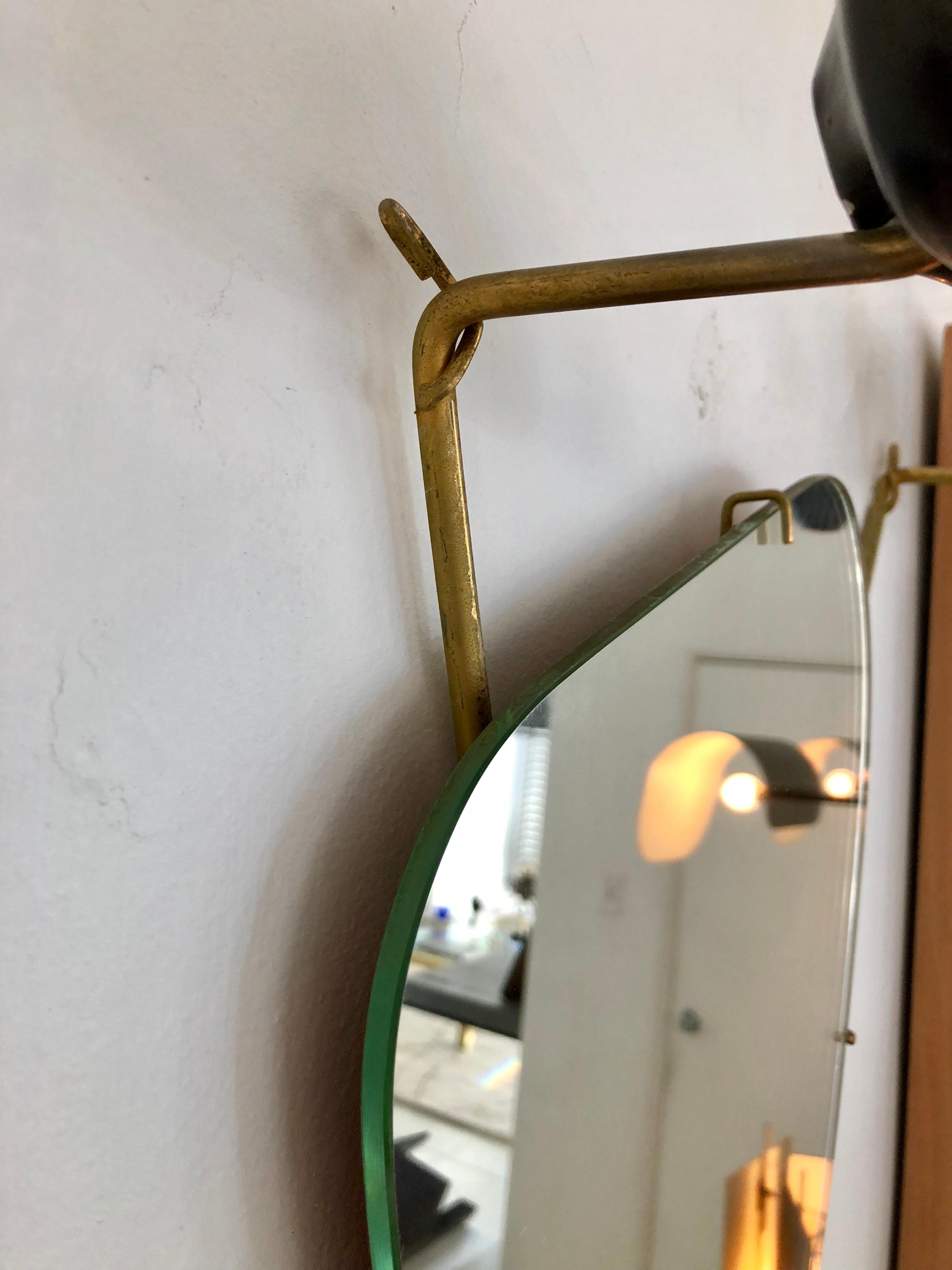 Wall-mounted coat rack with mirror by Georges Jouve. Asselbur, France, 1955. Glazed stoneware, mirrored glass, gilt steel.
Provenance: Galerie Chastel-Marechal, Paris. Private Collection.