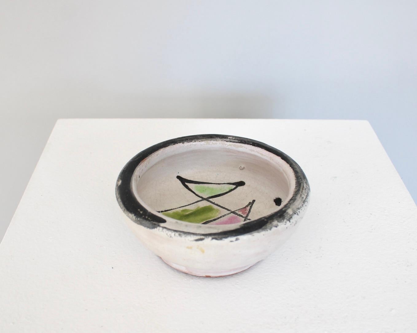 Georges Jouve French ceramic artist small dish with pink and green interior glaze. Black brushstroke on the rim. Signed with Jouve cypher. 
Excellent condition, no ships or restorations. 

 5.75w” x 3.5h