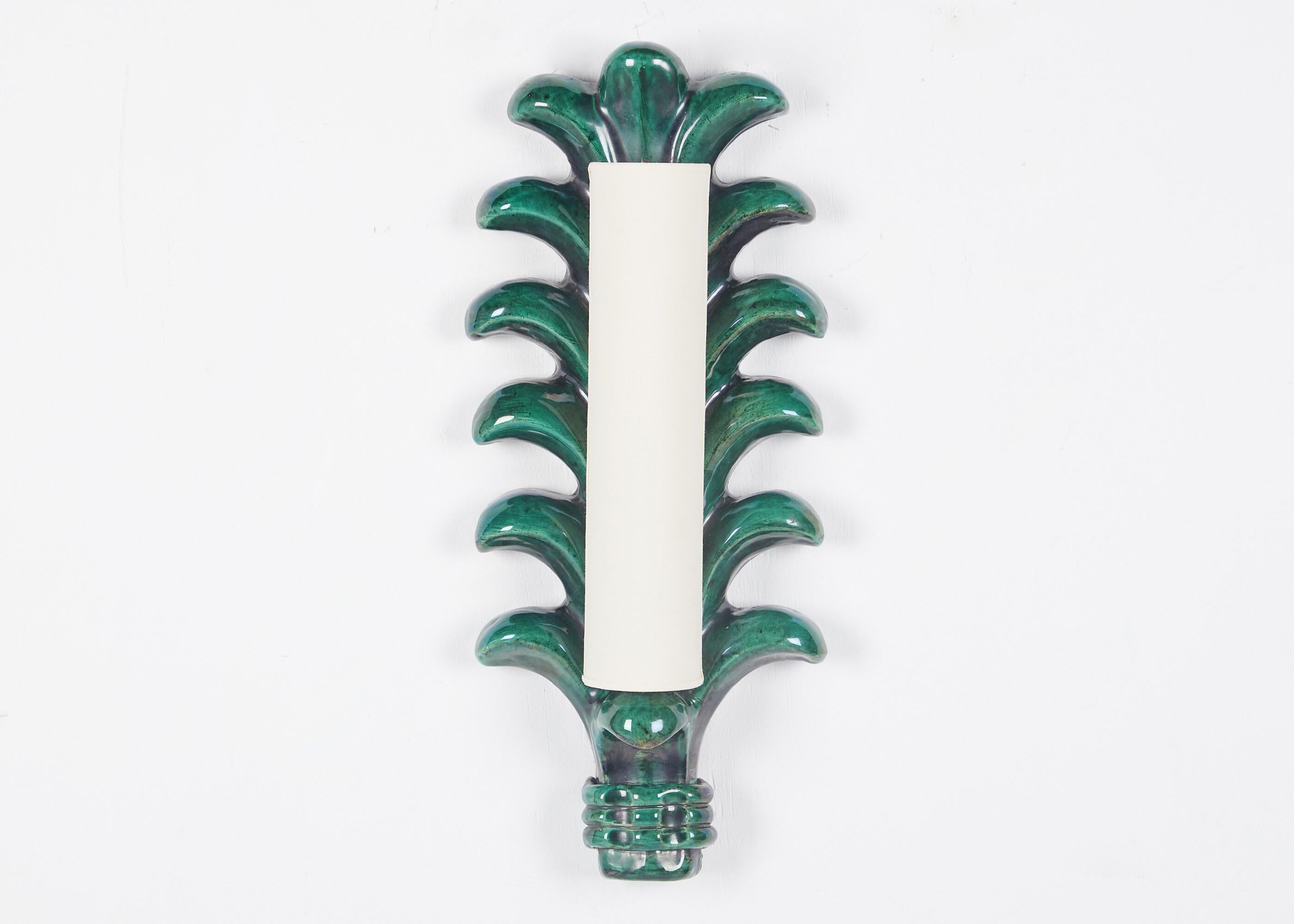 A mid-century, biomorphic sconce by French designer Georges Jouve, fired in a lush, variegated green glaze.  Signed on back. To our knowledge this may have been one of only five made in this beautiful green.