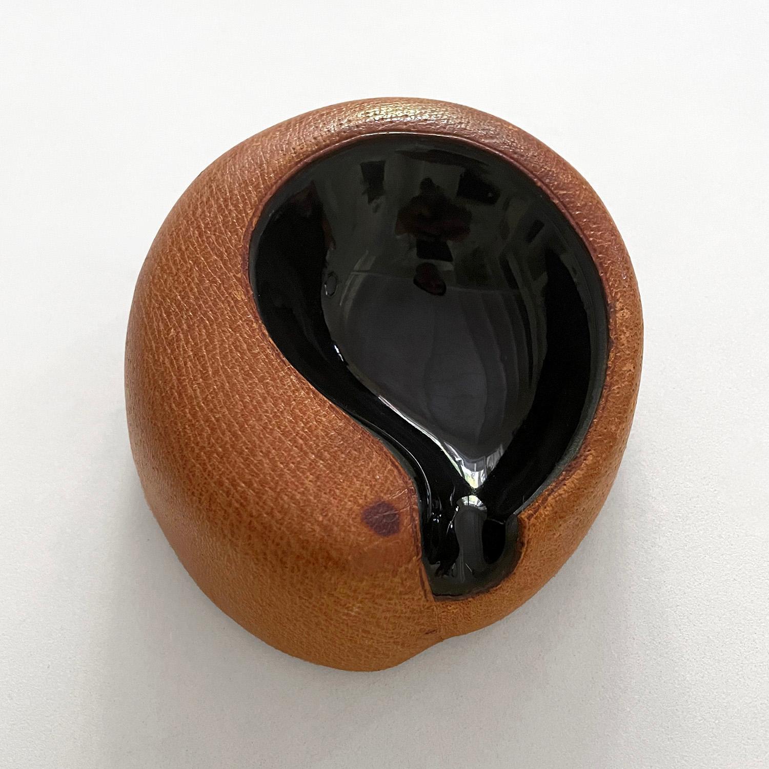 Georges Jouve ashtray
France, circa 1940’s
Rich saddle leather wraps the teardrop shaped ceramic ashtray
Light markings and patina to the leather add to the character and charm of this piece.
 