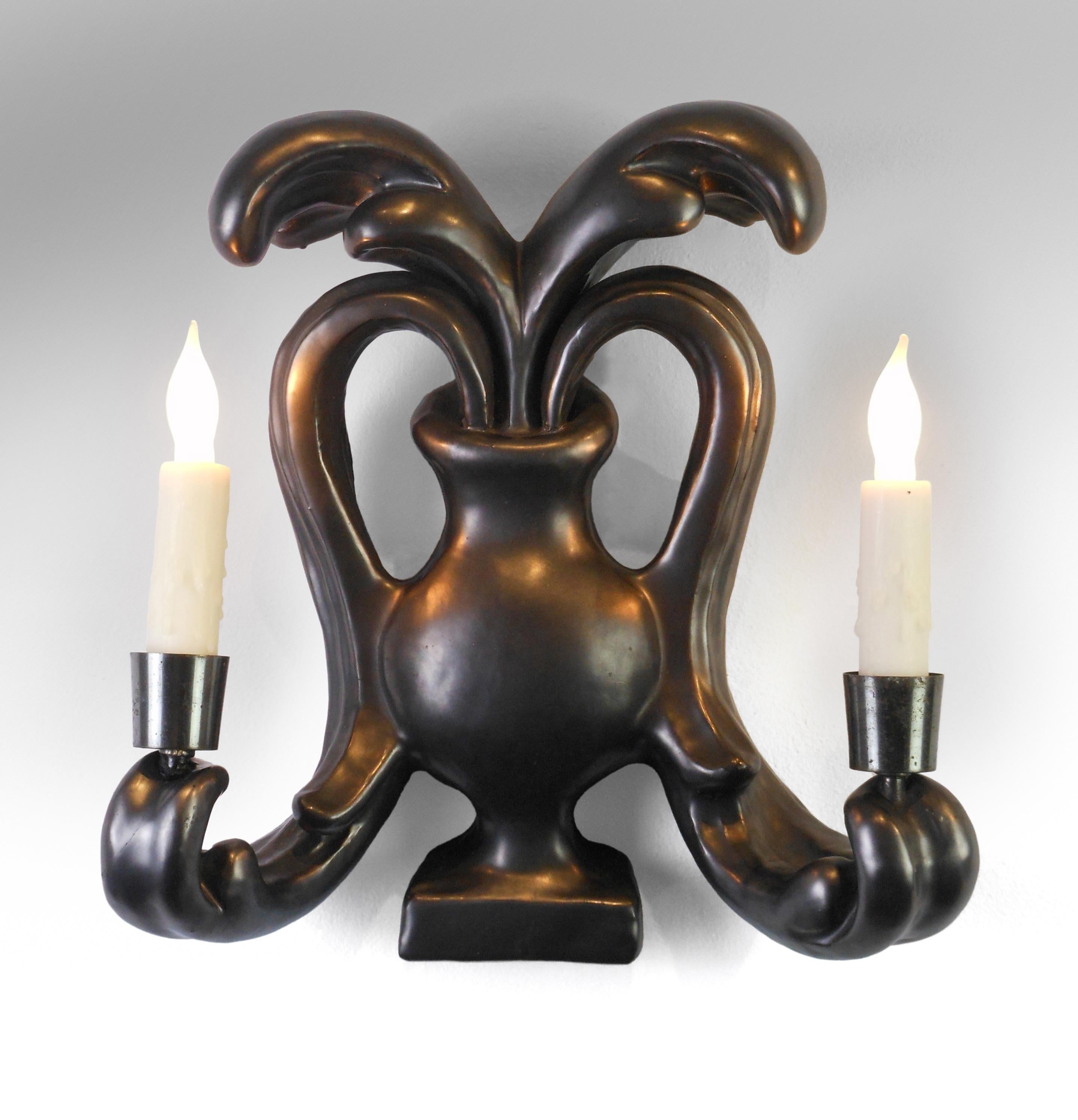 Georges Jouve, pair of French matt black glazed ceramic sconces
Mid-20th century
Classic Jouve, inventive, playful and disciplined. Each in the form of a baluster urn issuing scrolling acanthus leaf candle arms.
Georges Jouve (1910-1964) was one