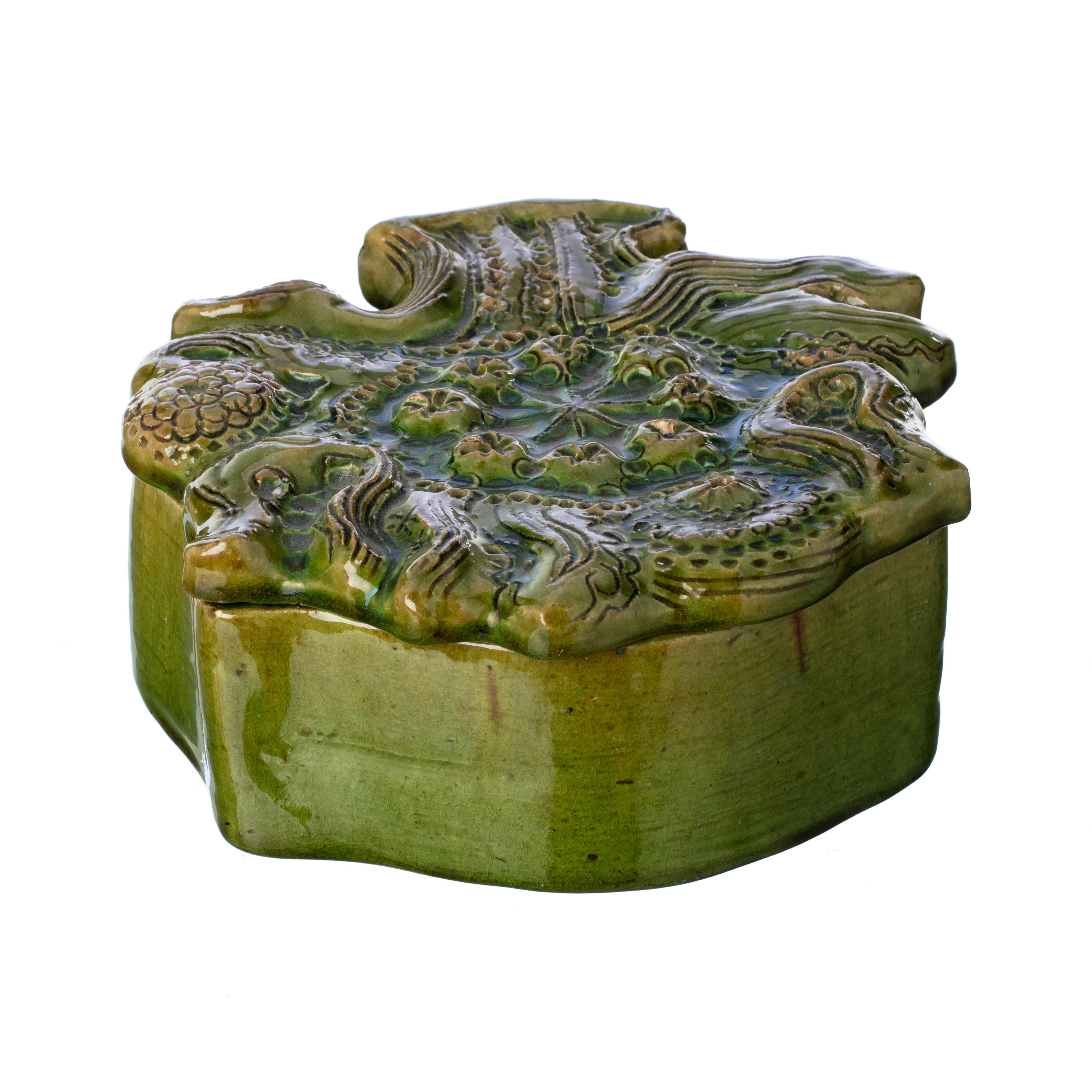 A ceramic green glazed jewelry box by Georges Jouve, c.1949. Of sculptural form wonderfully modelled representing the 'tree of life'. Incised signed ''Apollon' mark on backside. Provenance: Private French Collection.