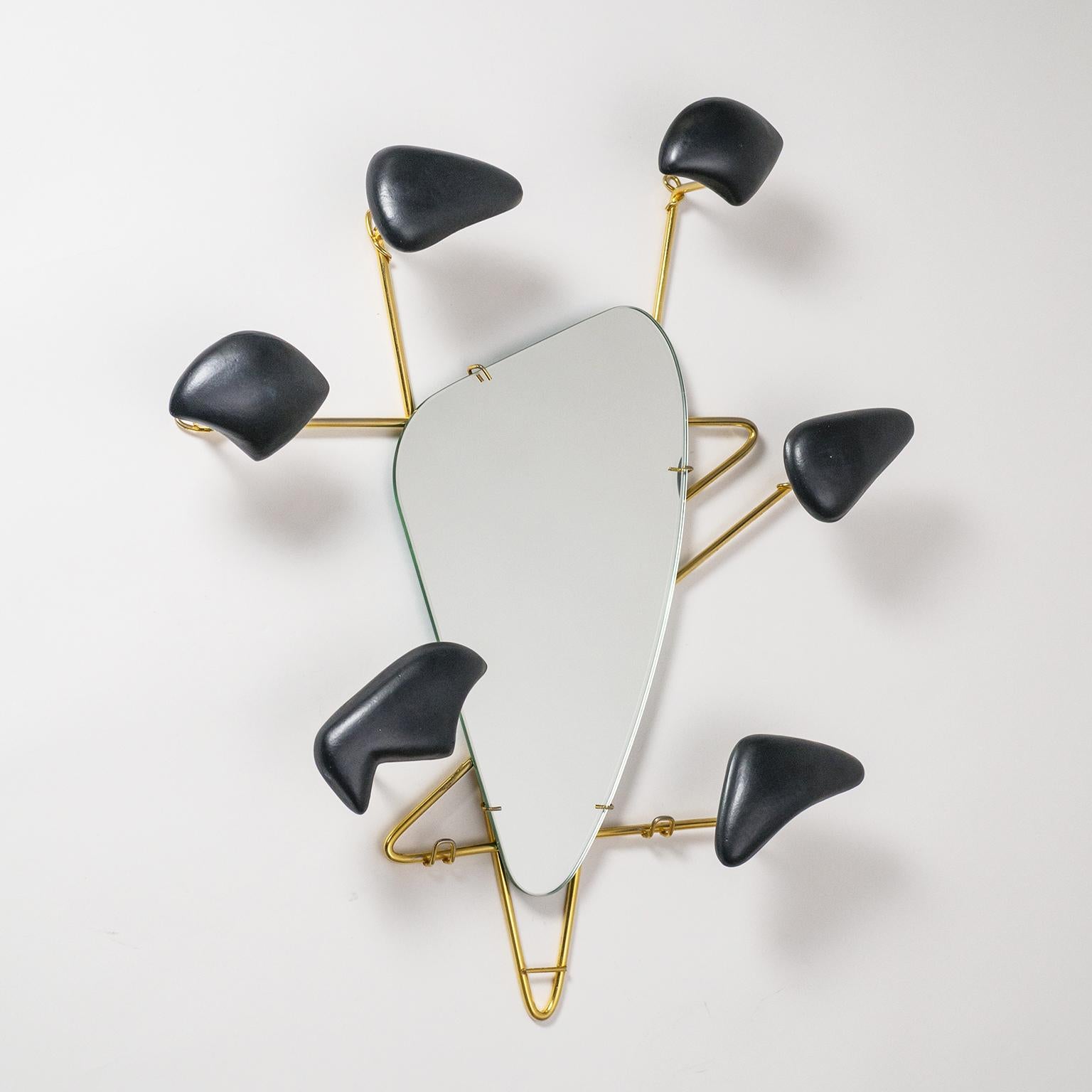 Stunning sculptural mirror by Georges Jouvé for Marcel Asselbur. Rare six arm version, each with an abstract Jouvé ceramic form which can support a hat or coat. 