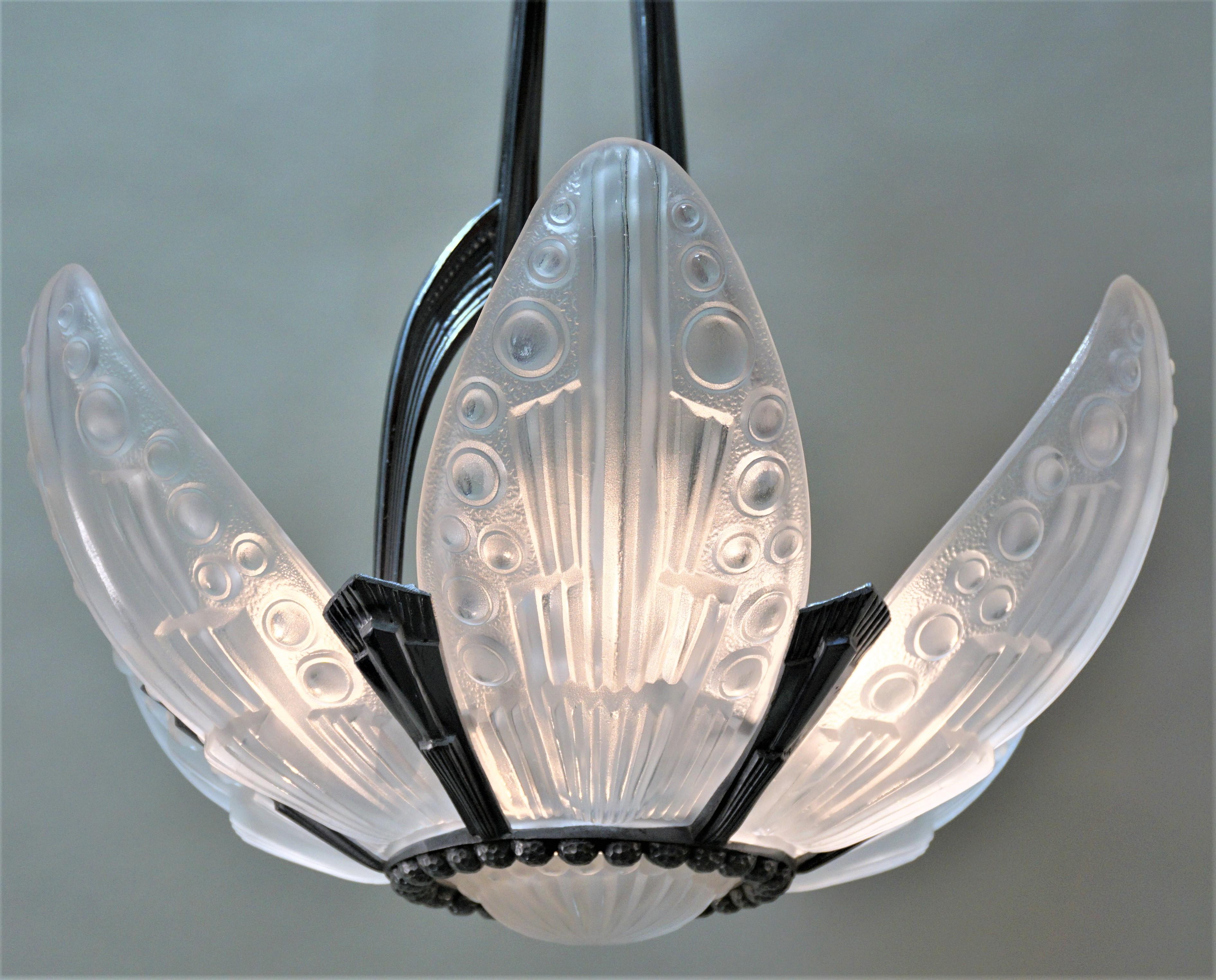 1930s French Art Deco chandelier, seven molded clear frost glass with high light polish and chrome on bronze frame.