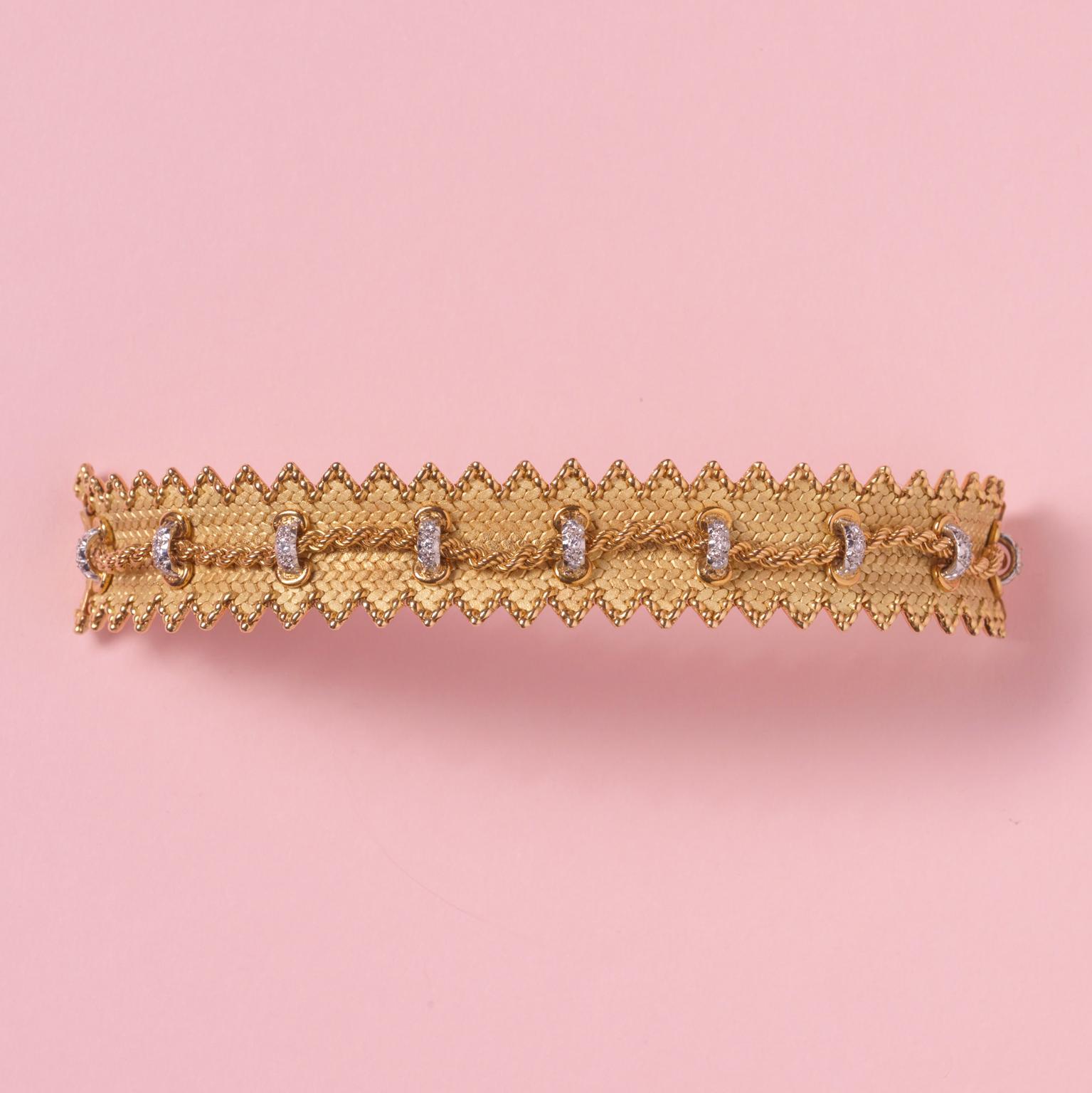An important wide 18 carat gold bracelet by Georges Lenfant designed as a woven strap with textured matte finish and highly polished finish on a jagged border of each side of the bracelet, in the middle is gold cord that is held by platinum and