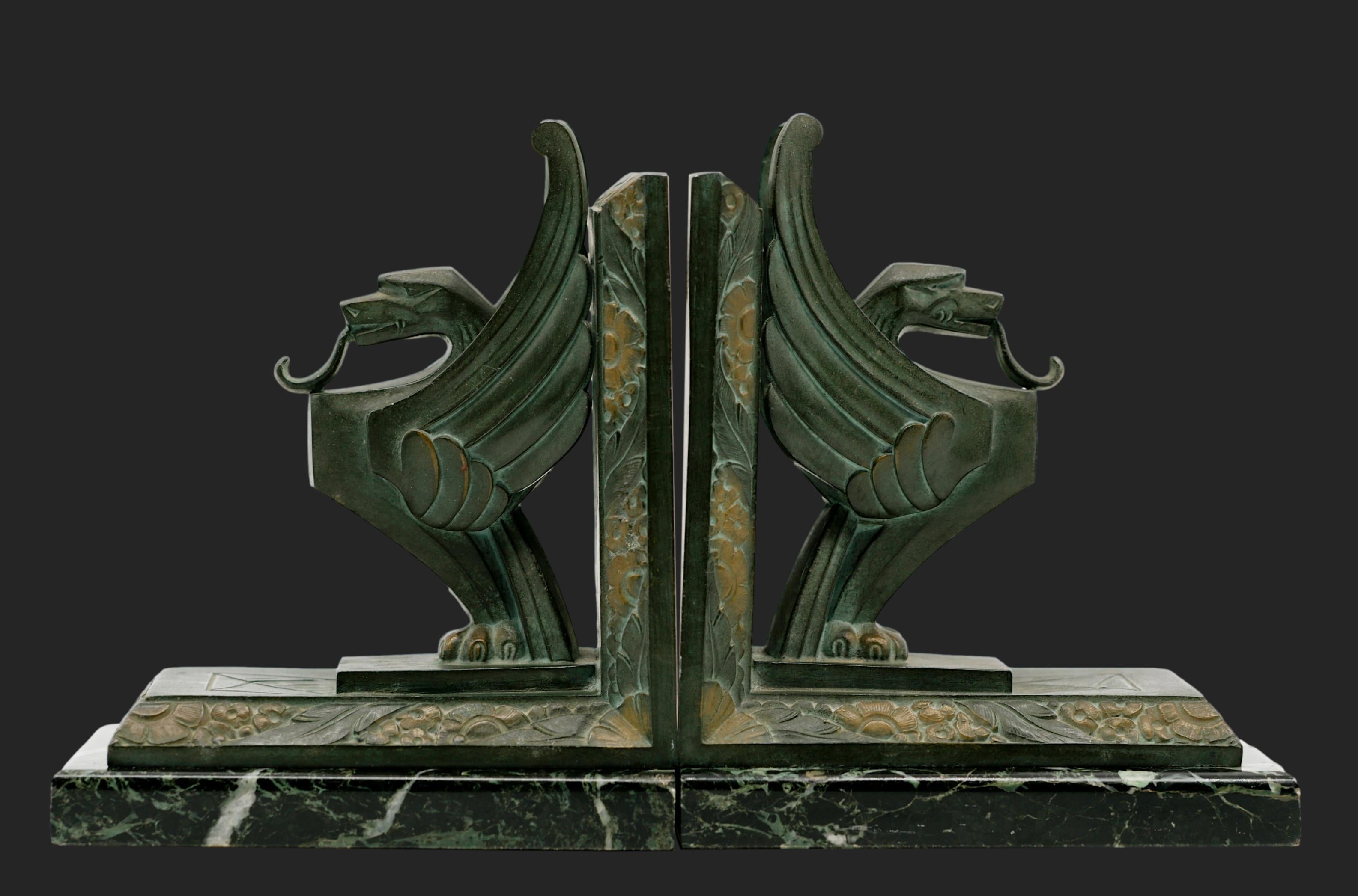 French Art Deco griffin bookends by Georges LIMOUSIN (Paris), France, early 1920s. Crafted from spelter and marble, these bookends feature majestic griffins, a striking symbol of strength and elegance, typical of the Art Deco style. Each bookend
