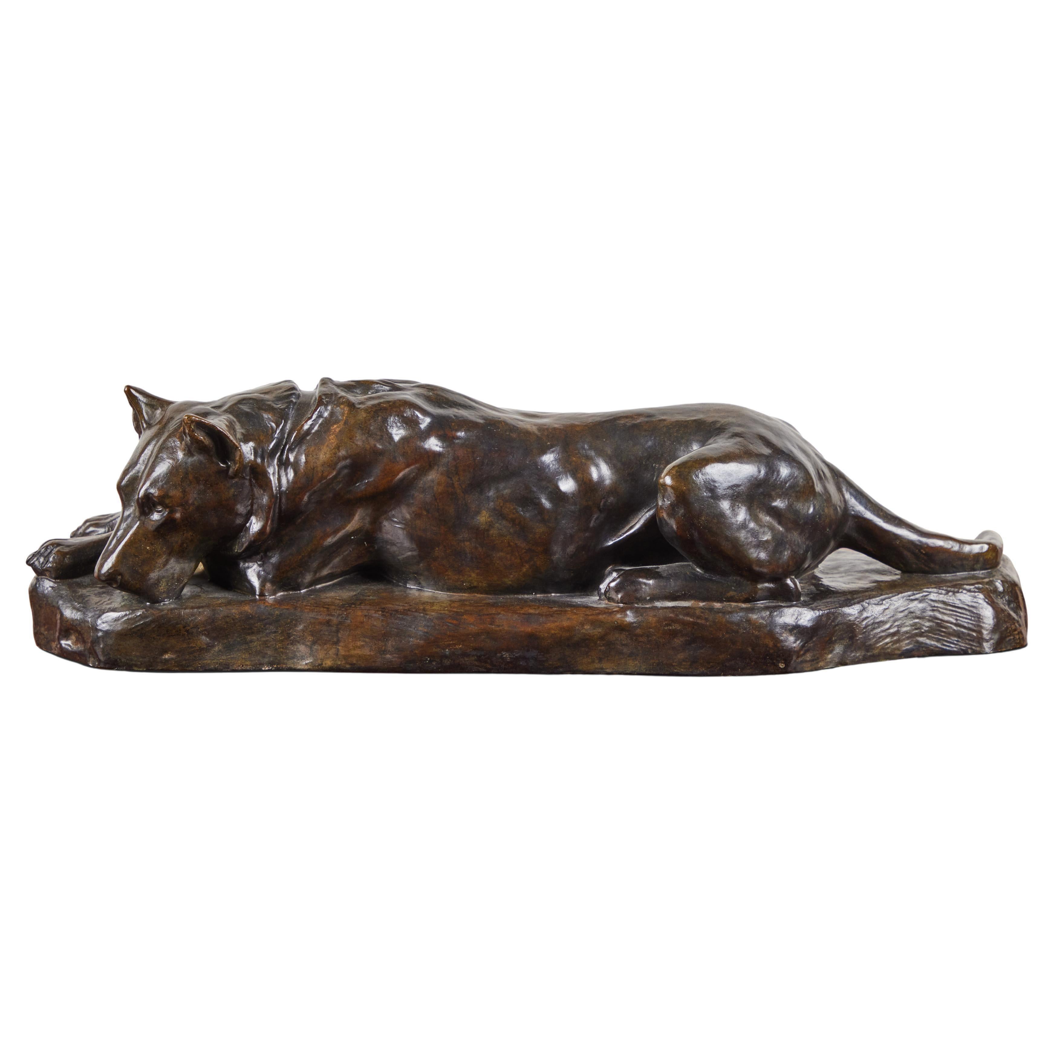 Sensitively rendered, hand-cast, signed bronze sculpture of a resting dog on a naturalistic base of the same by listed French artist, Georges Lucien-Guyot (1885-1973). The animal is relaxed with head on crossed paws- a familiar and charming